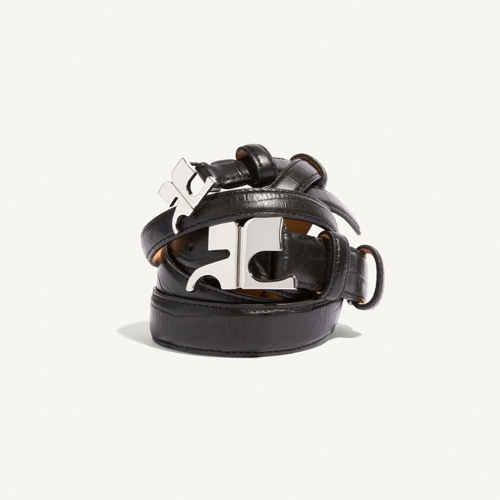 Elegant black leather belt with distinctive silver buckle, by Courrèges, for stylish fashion.