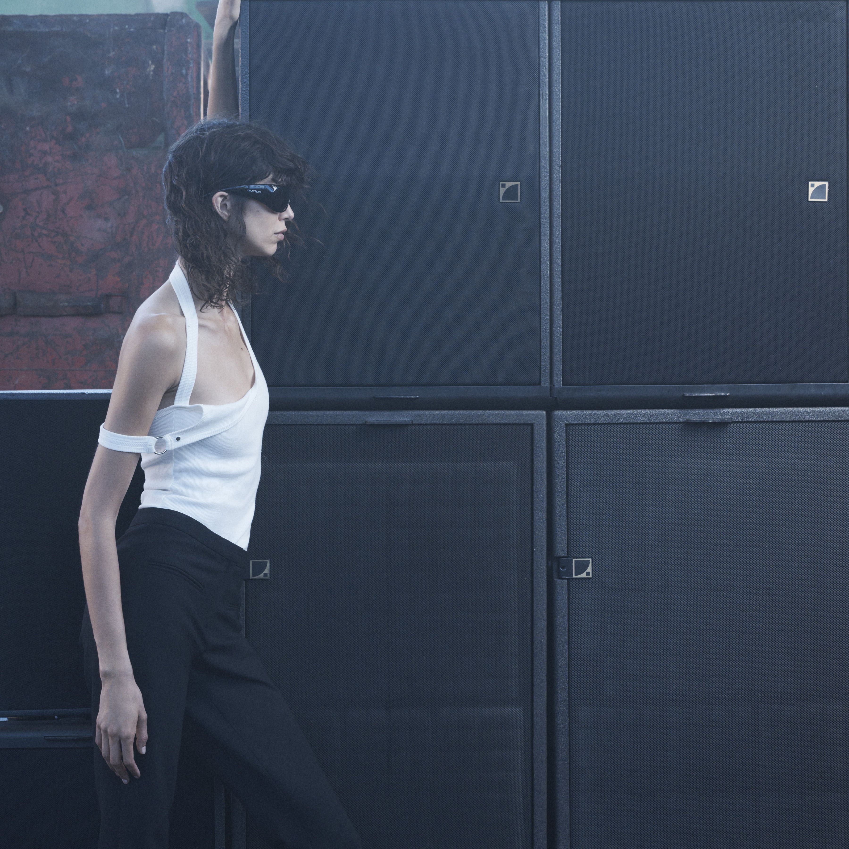 Elegant model in stylish Courrèges fashion apparel with futuristic accessories, ecommerce site.