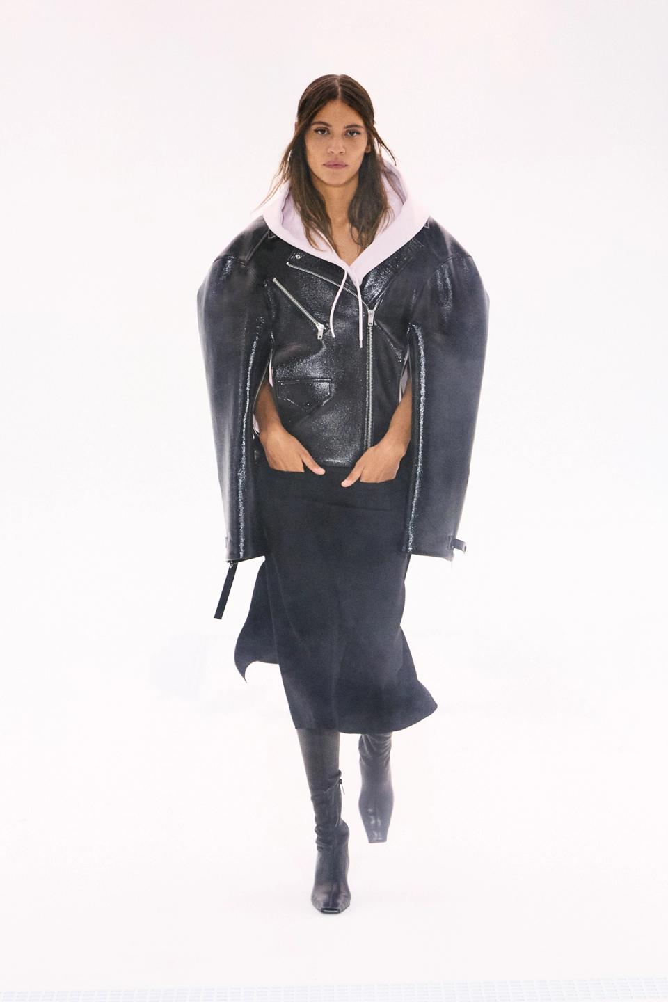 Elegant black leather jacket layered over a white hoodie, showcasing Courrèges fashion.