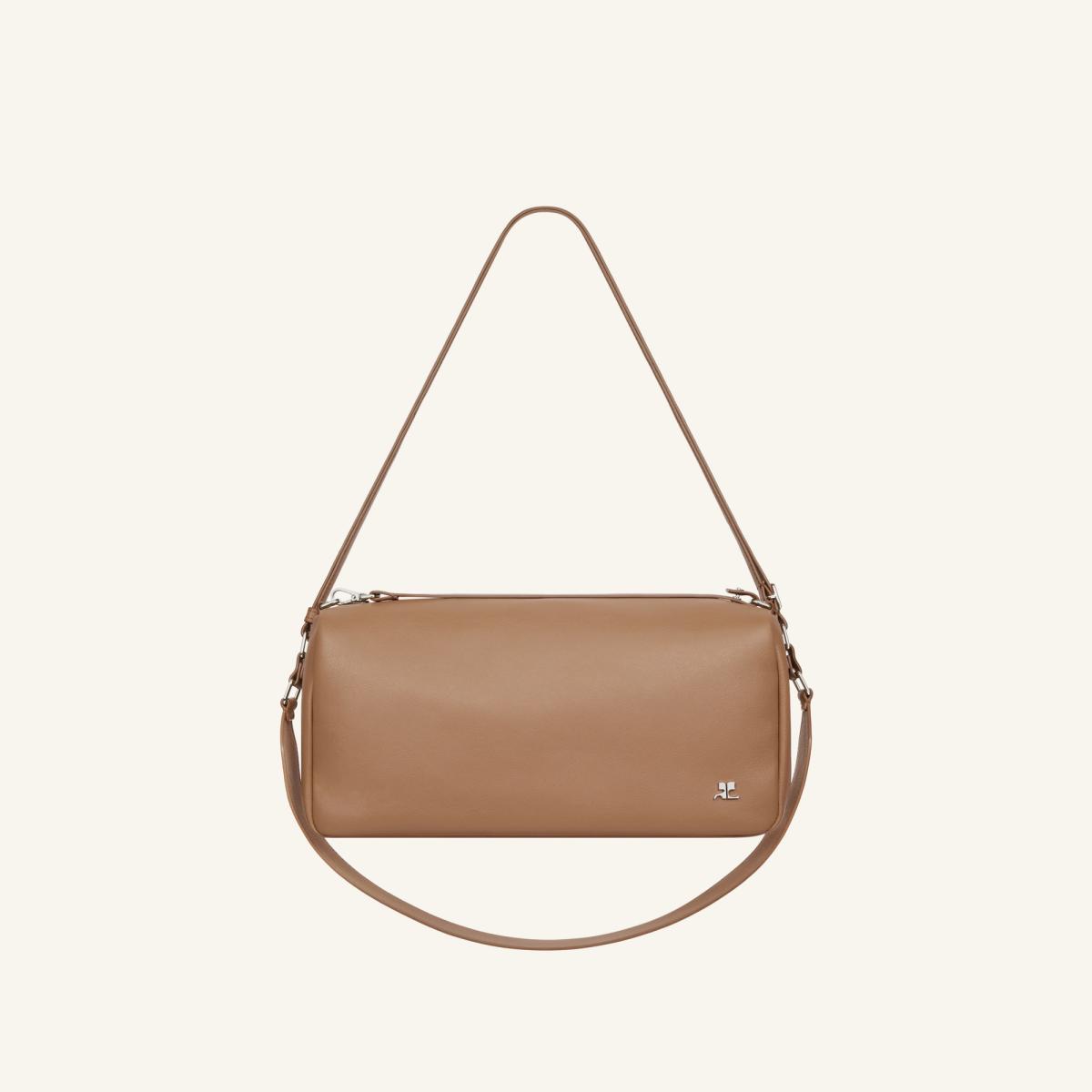 Elegant beige Courrèges handbag with a sleek cylindrical shape, perfect for fashion essentials.