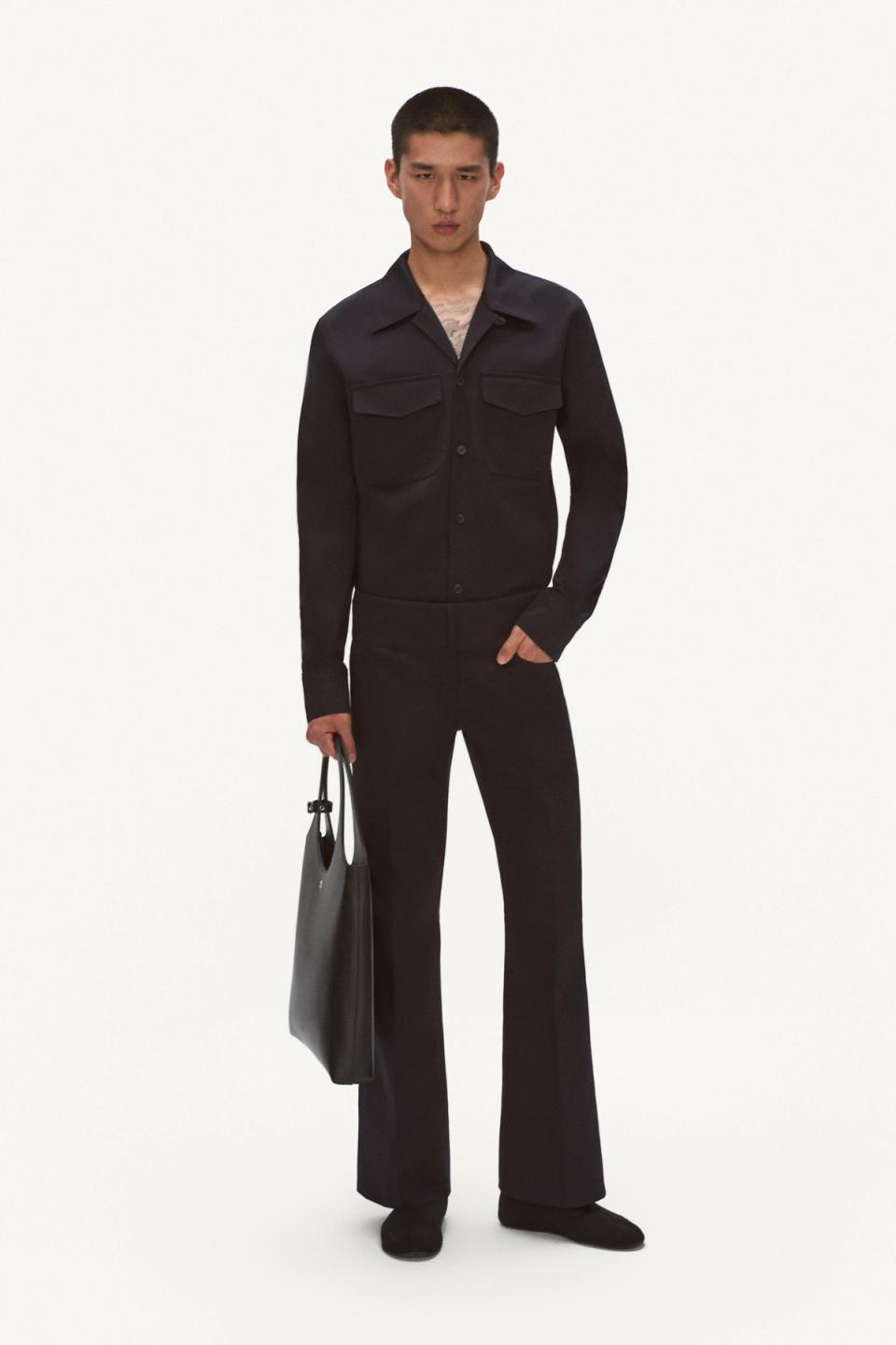 Elegant black fashion ensemble featuring a tailored jacket and flared pants for Courrèges.