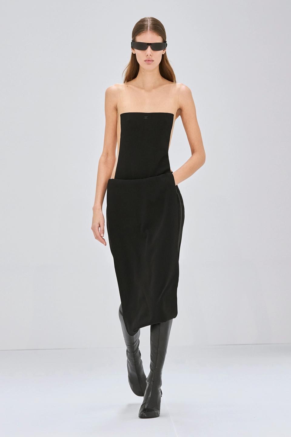 Elegant black strapless dress by Courrèges paired with sleek knee-high boots for fashion.
