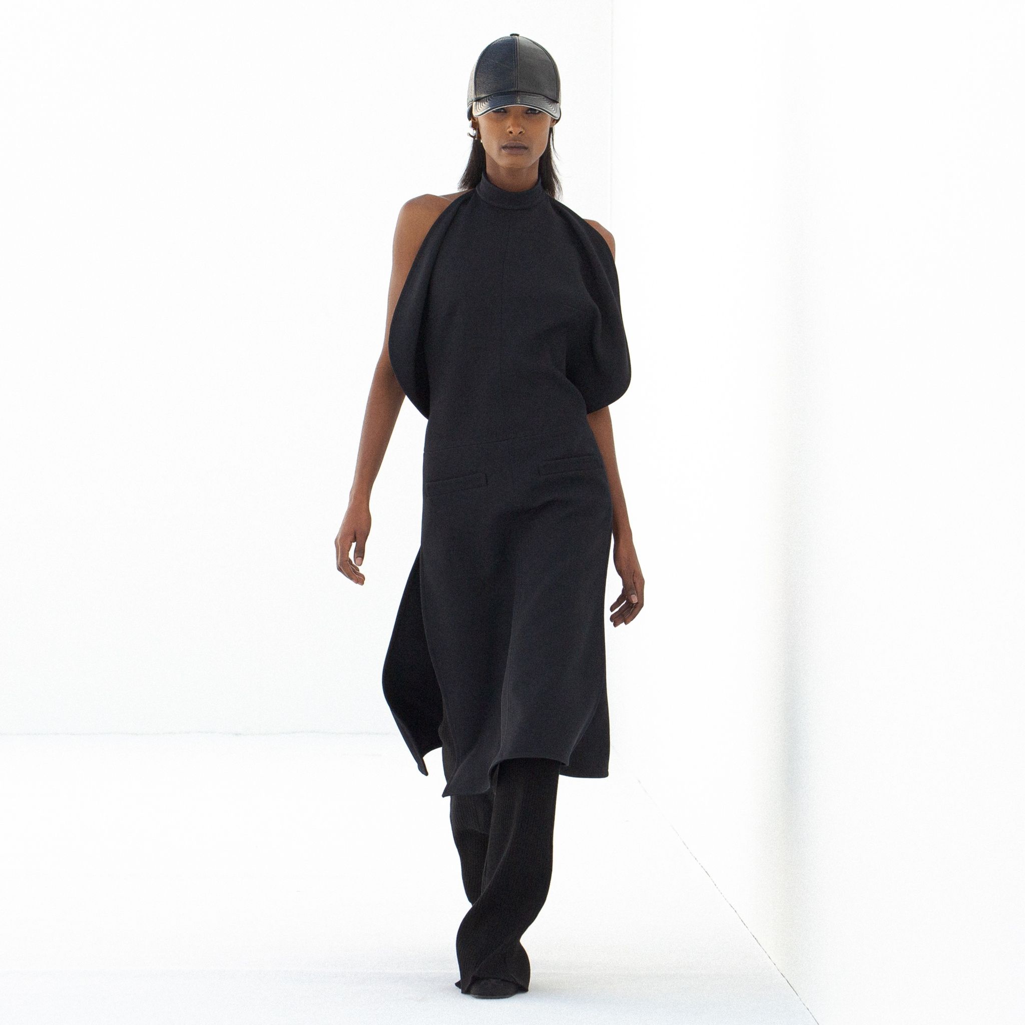 Elegant black dress with unique draped design, part of Courrèges' modern fashion collection.
