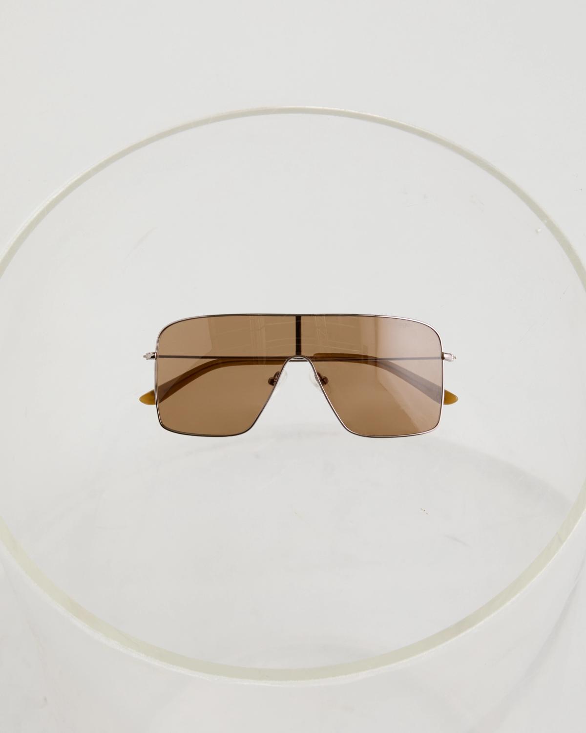 Courrèges sunglasses with oversized rectangular brown lenses and sleek metallic frames, shown on a white background.