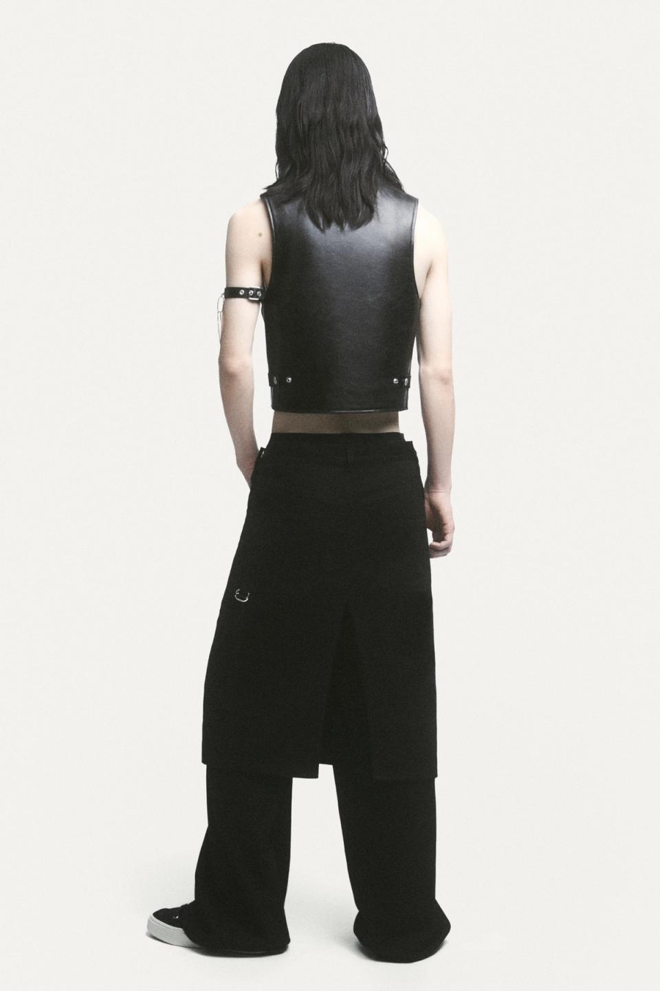 Elegant black leather vest and wide-leg black pants showcased by Courrèges on an ecommerce site.