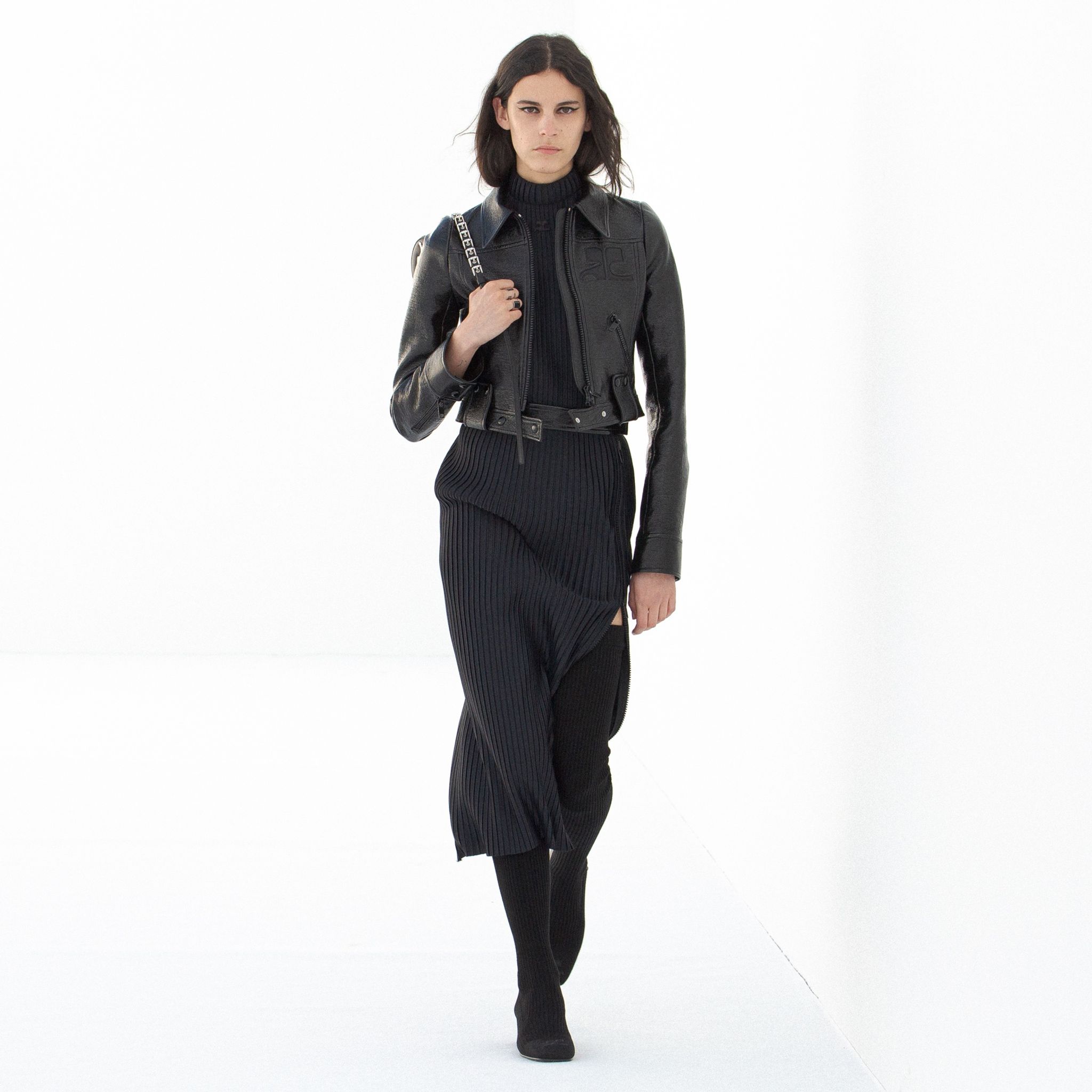 Elegant black leather jacket paired with a stylish black skirt, showcasing Courrèges fashion.
