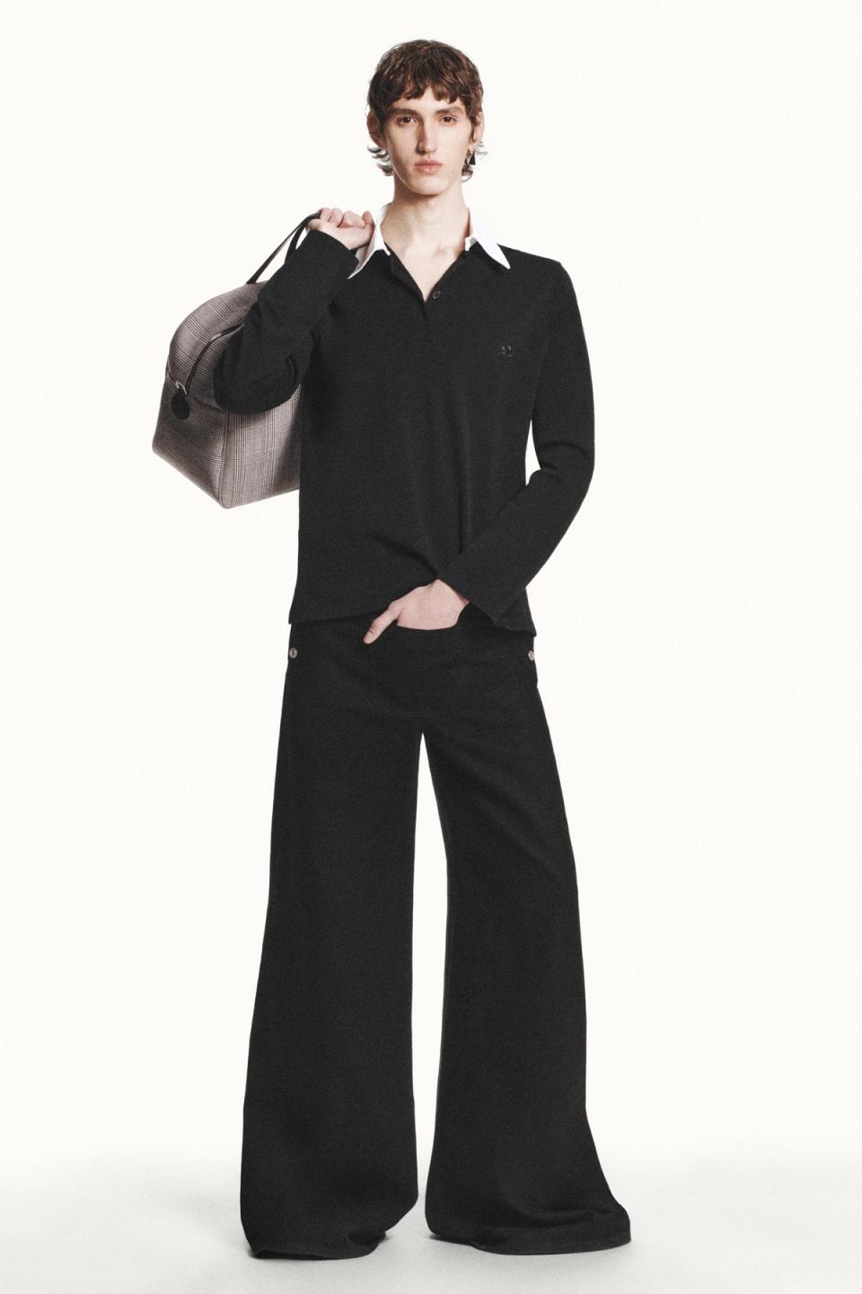 Elegant black and white fashion look from Courrèges, featuring wide-leg pants and a sweater.