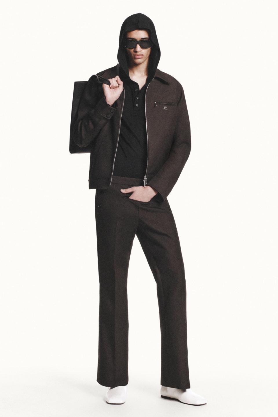 Elegant Courrèges fashion look featuring a dark jacket, hoodie, sunglasses, and stylish pants.