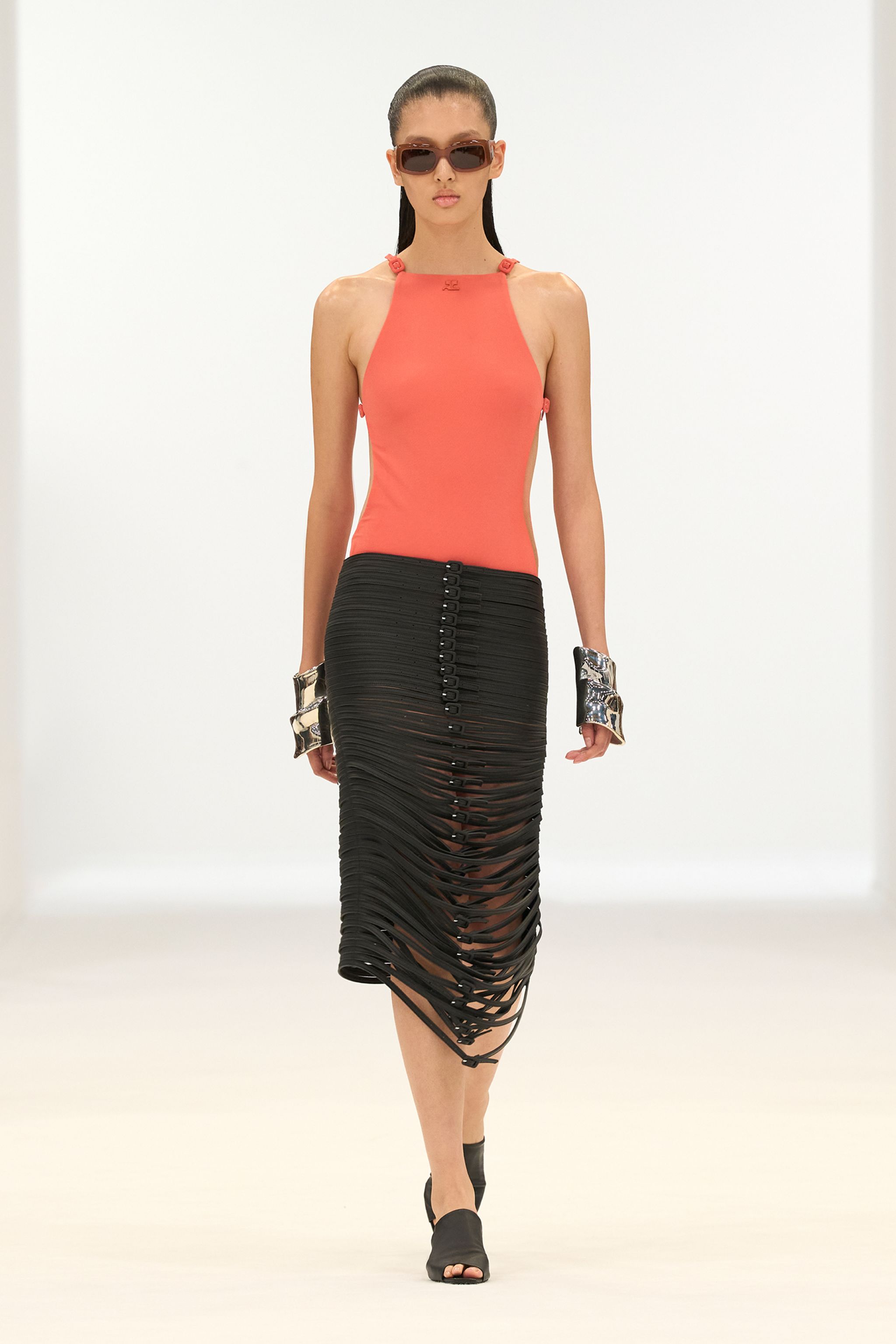 Elegant black and coral fashion ensemble showcasing Courrèges' contemporary style on the runway.