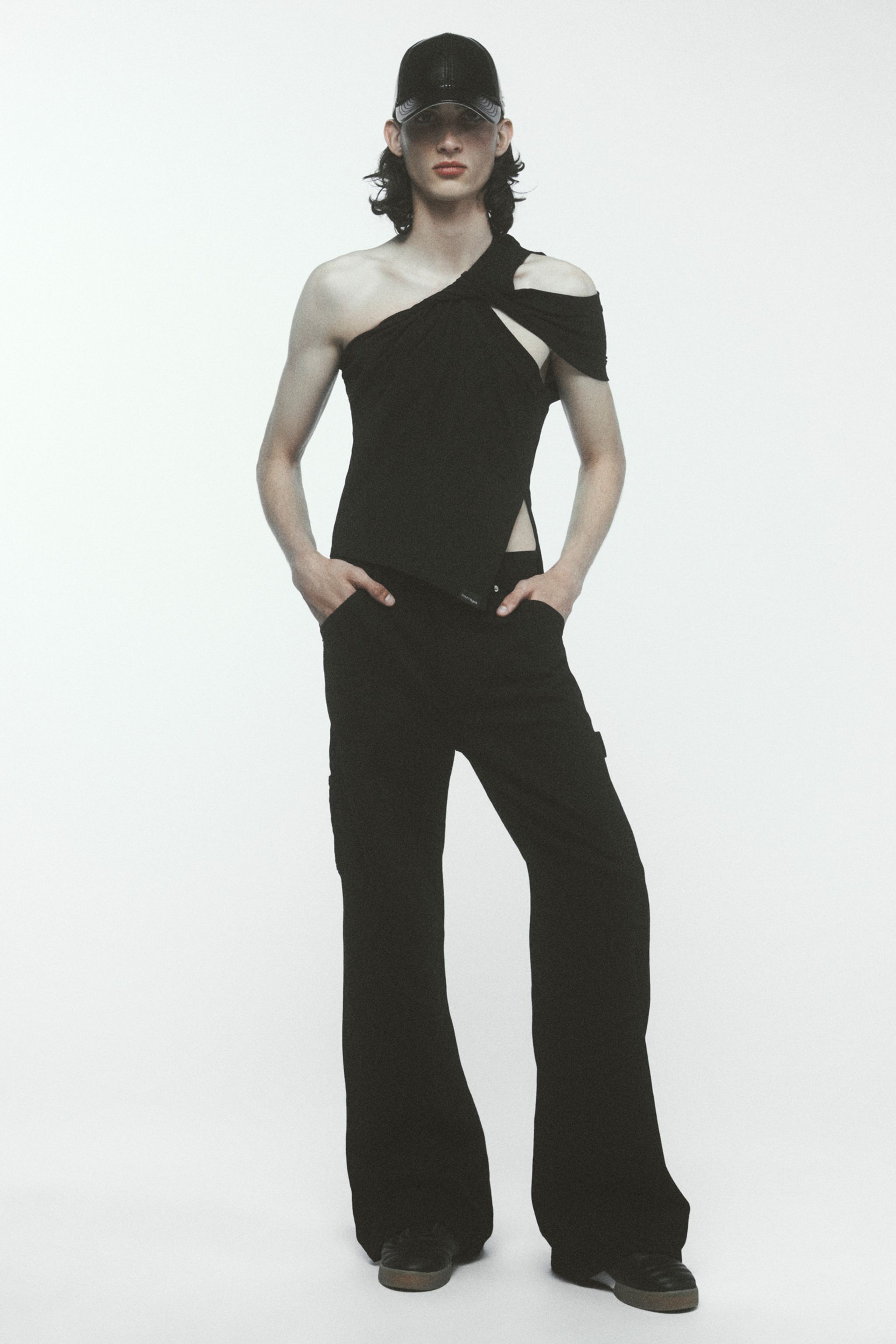 Elegant black modern Courrèges fashion ensemble featuring a unique cut-out top and wide-leg pants.