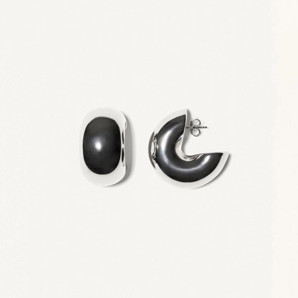 Elegant black and silver earrings, brand Courrèges, showcased on a white background.