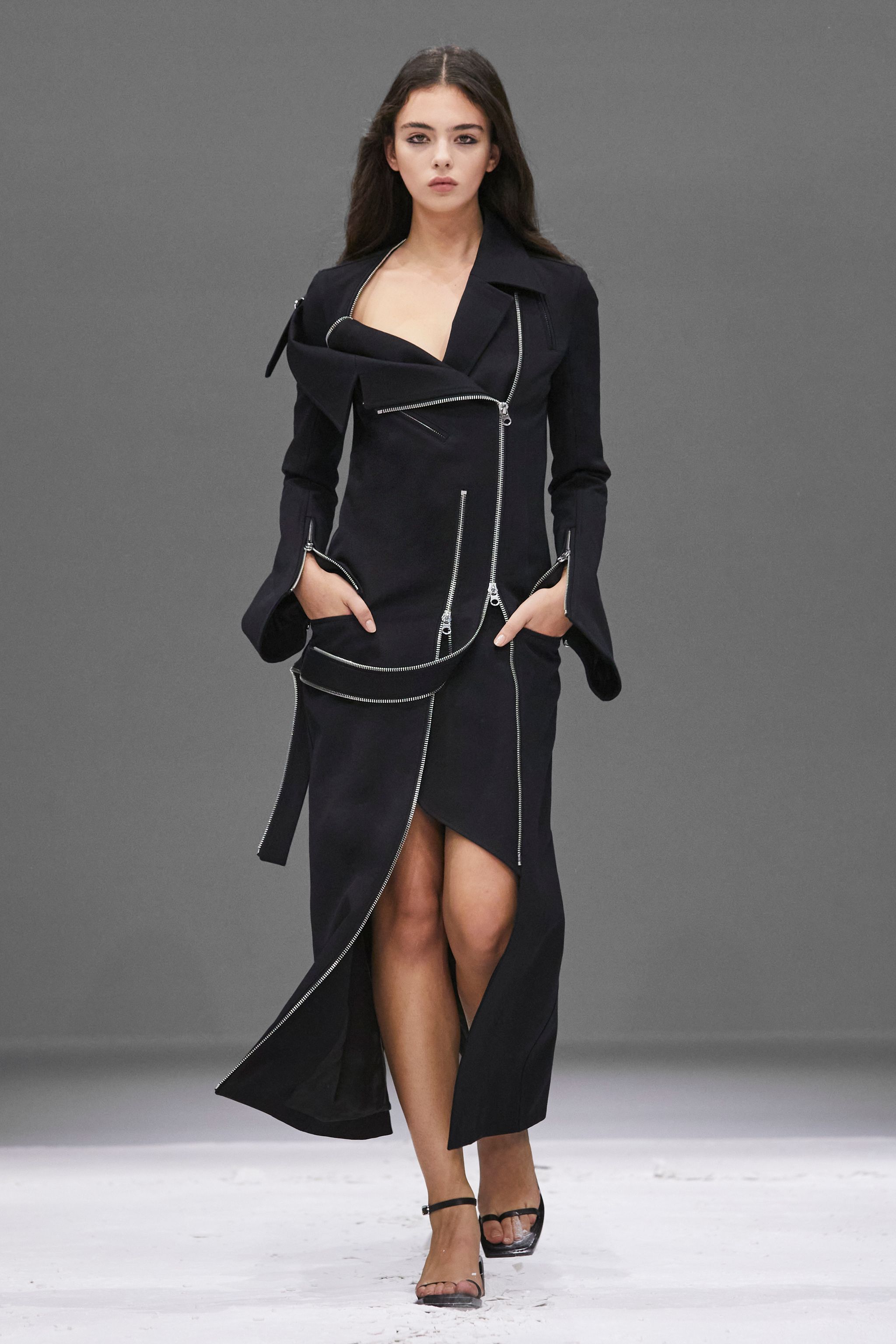 Elegant black avant-garde jacket and skirt ensemble from Courrèges for modern fashion lovers.