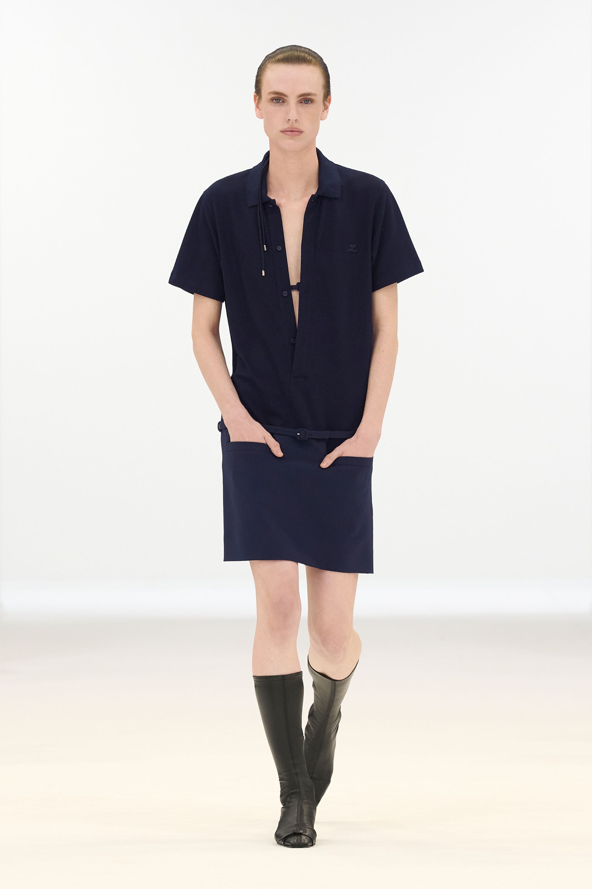 Elegant navy dress and shirt with modern style, showcased by Courrèges on model for shopping.