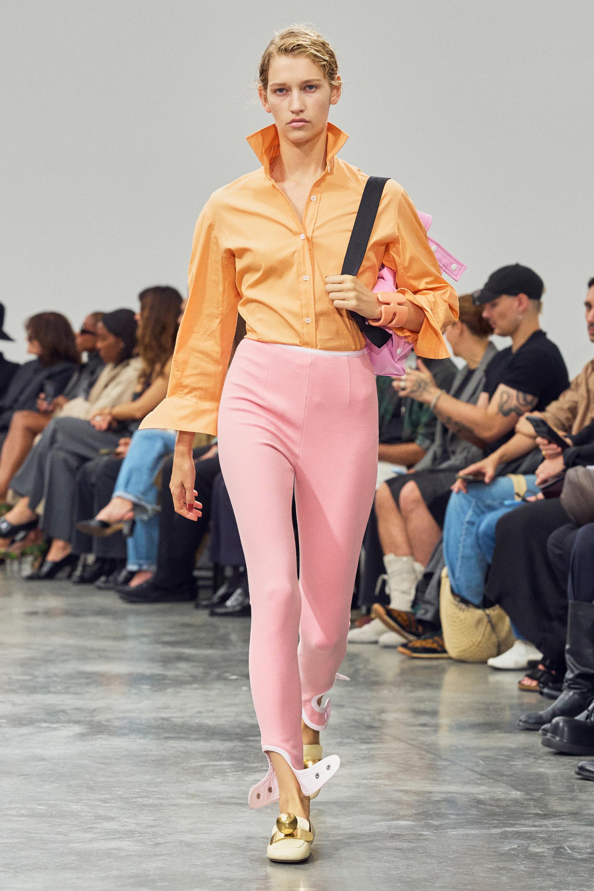 Fashion model wearing colorful designer outfit, showcasing Courrèges collection on runway.