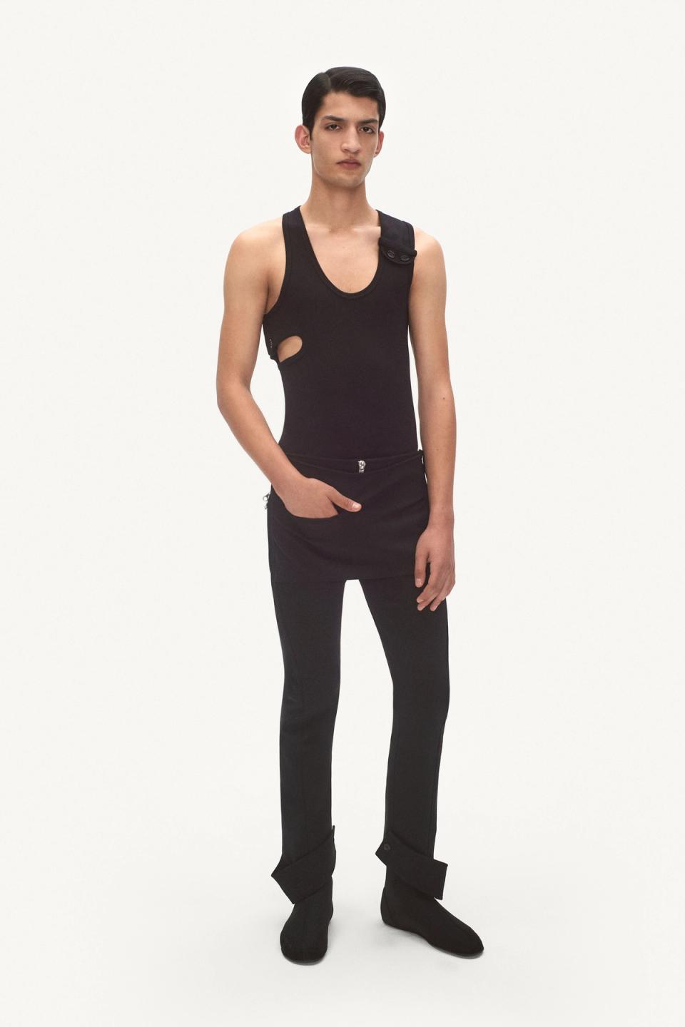 Elegant black sleeveless top with cutouts, styled with matching black pants for Courrèges.