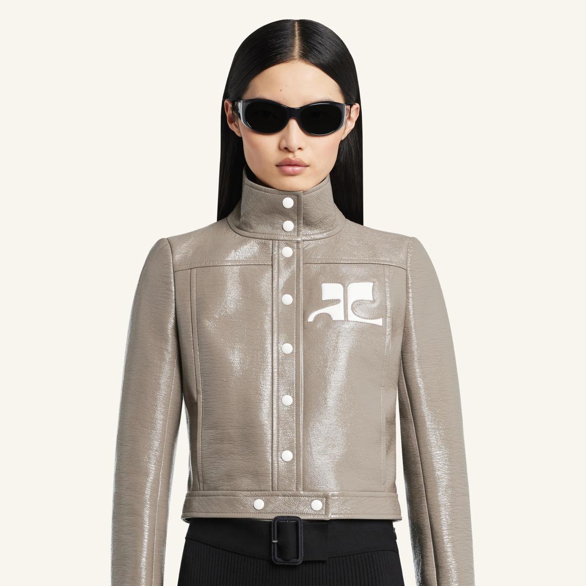 Elegant beige leather jacket from Courrèges with a high collar and futuristic design.