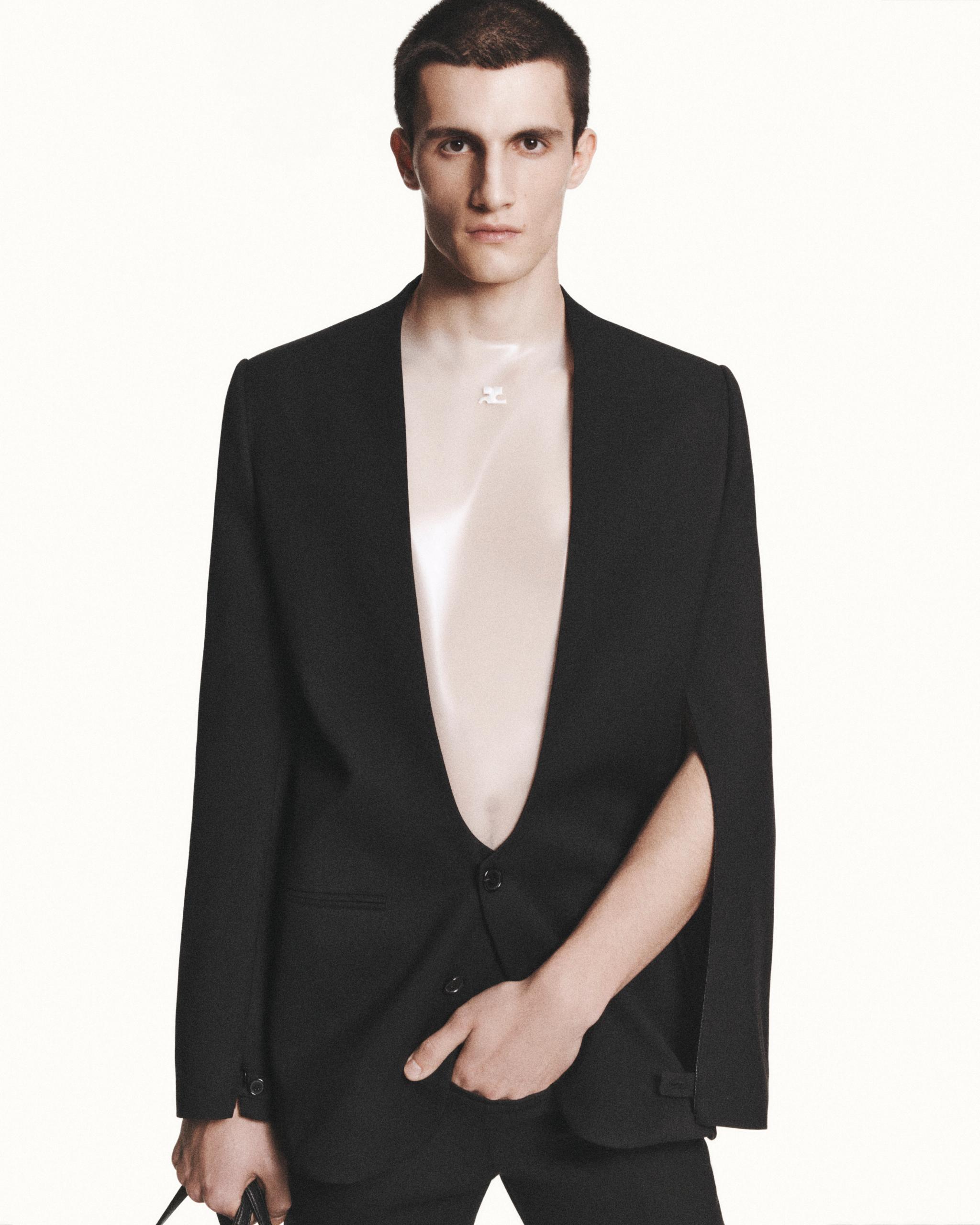Elegant black blazer with plunging neckline showcasing Courrèges' modern fashion aesthetic.