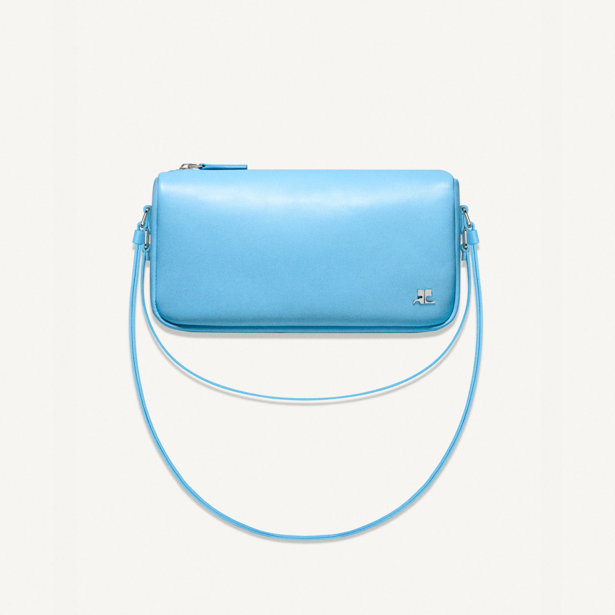 Elegant light blue Courrèges handbag with logo, perfect for a chic fashion look.