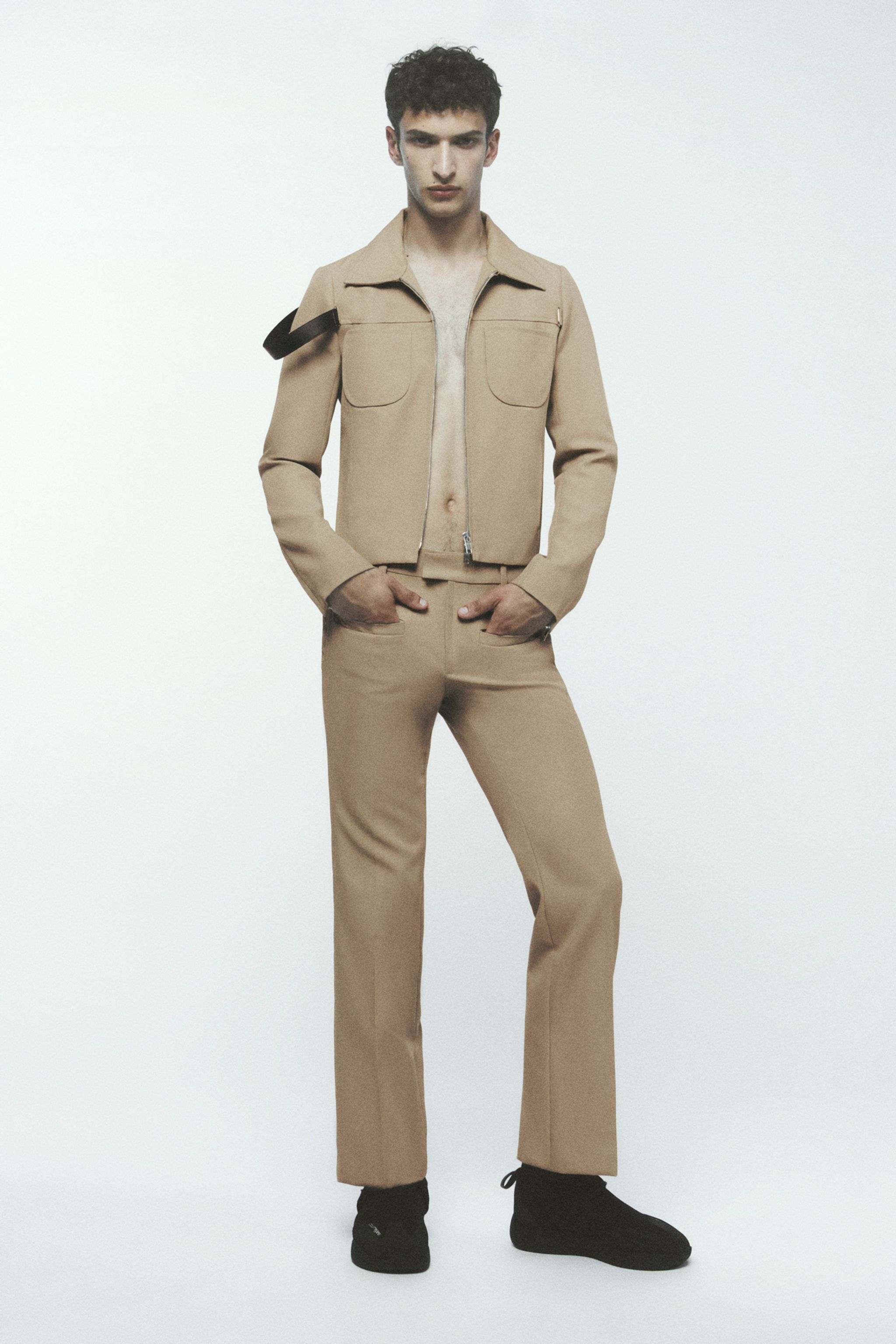 Elegant beige jacket and pants from Courrèges, styled for a modern fashion look.