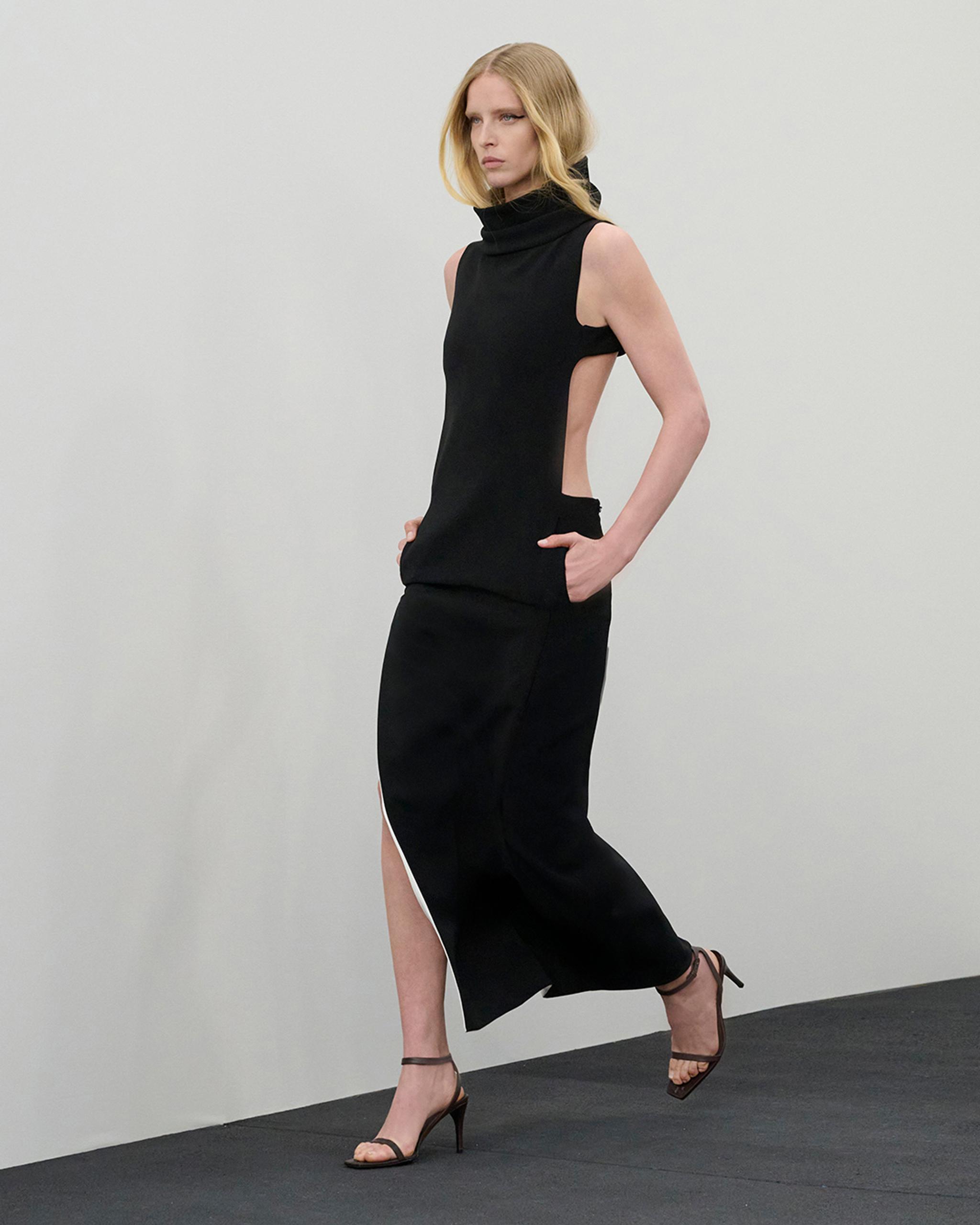 Elegant black sleeveless halter dress with side cutouts, ideal for Courrèges fashion collection.