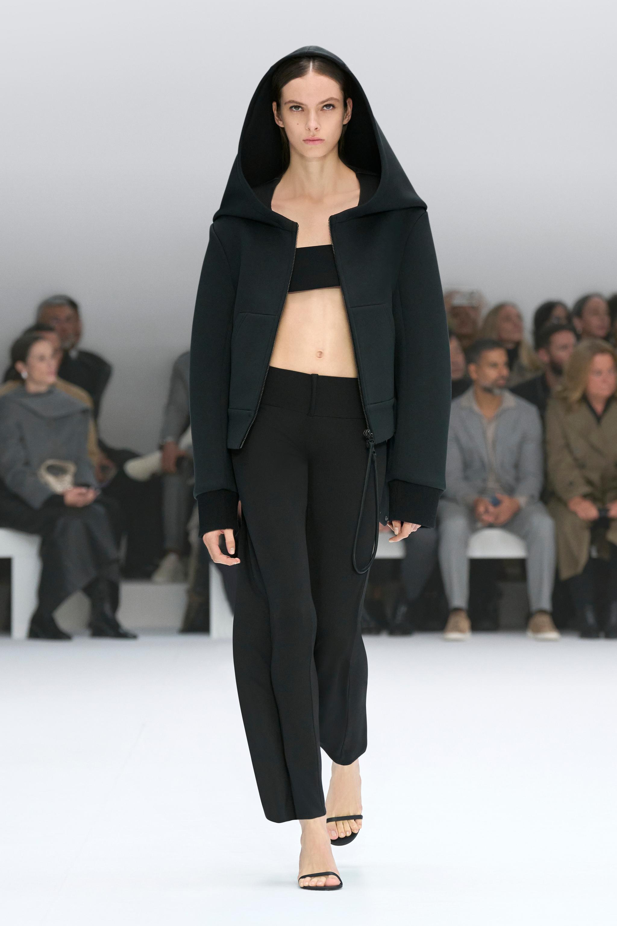 Elegant model showcasing Courrèges athleisure apparel at a fashion runway event.