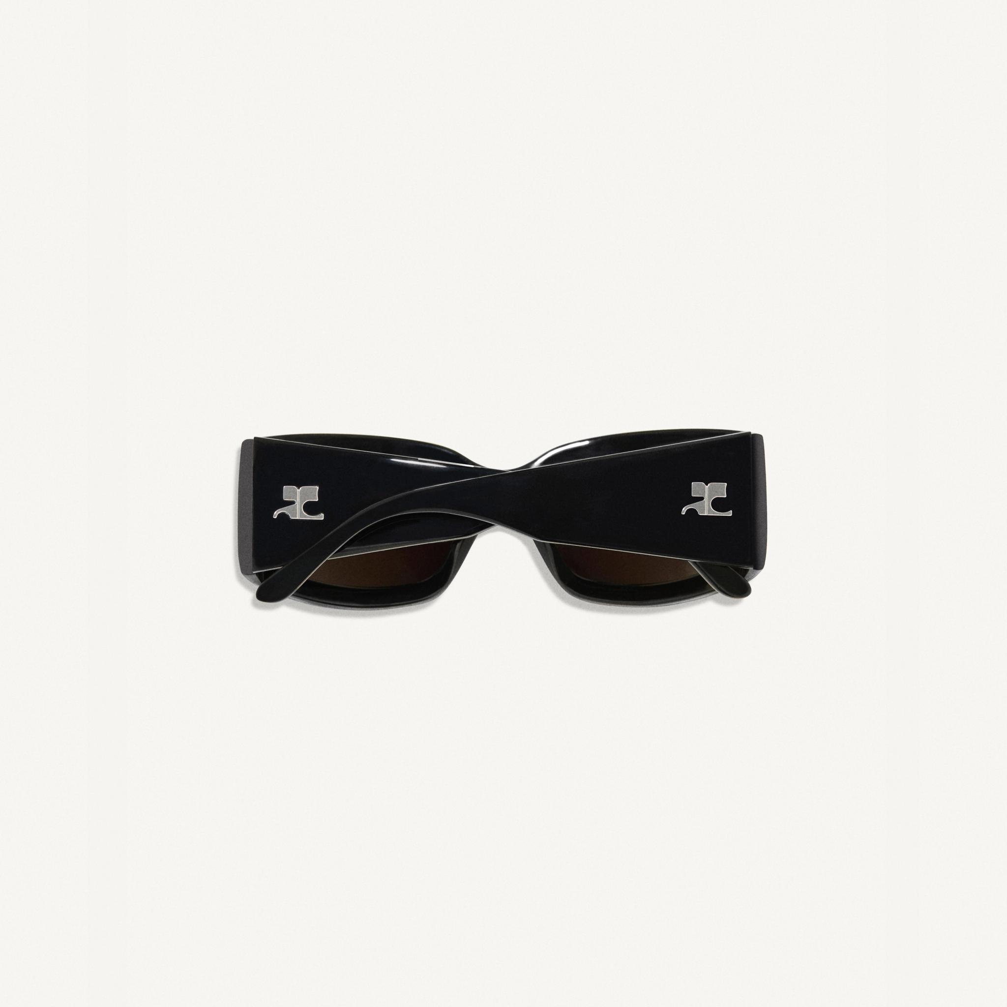 Elegant black sunglasses with the Courrèges logo, stylish accessory for a fashion-forward look.