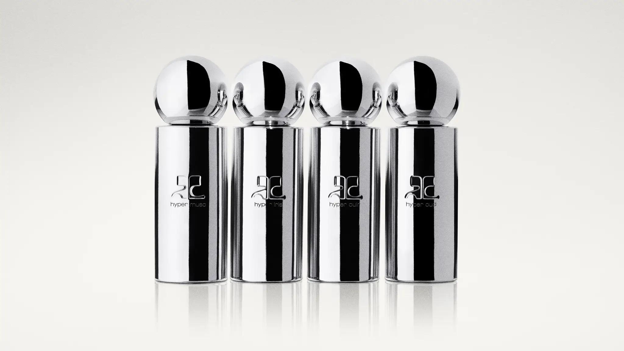 Elegant silver perfume bottles with spherical caps, styled for Courrèges' modern fashion collection.