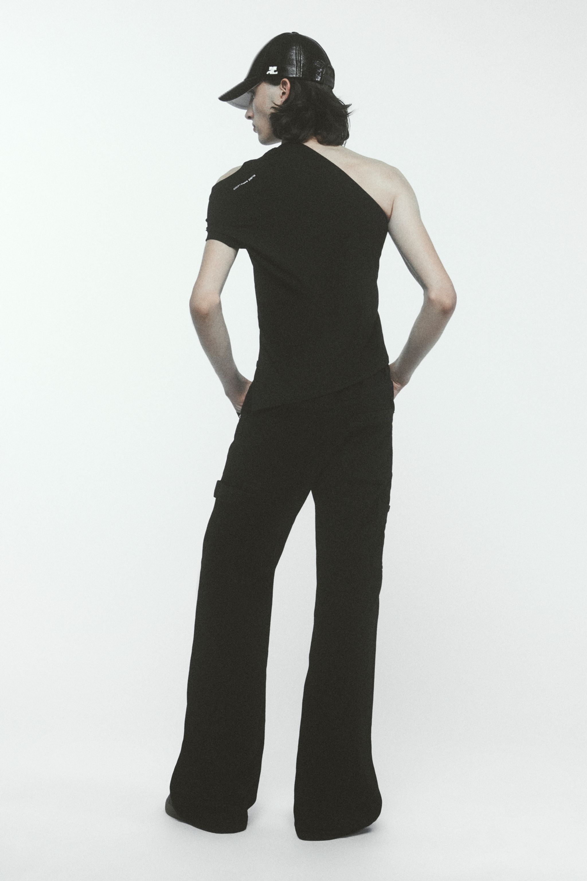 Elegant black asymmetric top and wide-leg pants from Courrèges, showcasing modern style.