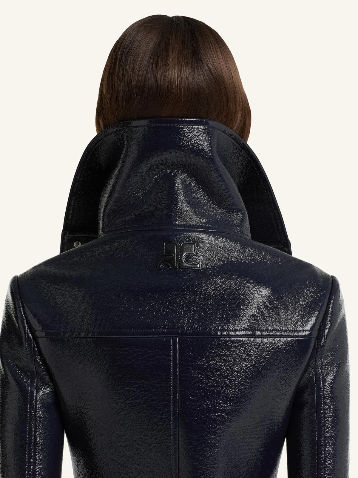 Elegant black leather jacket with high collar, featuring Courrèges branding, perfect for fashion lovers.
