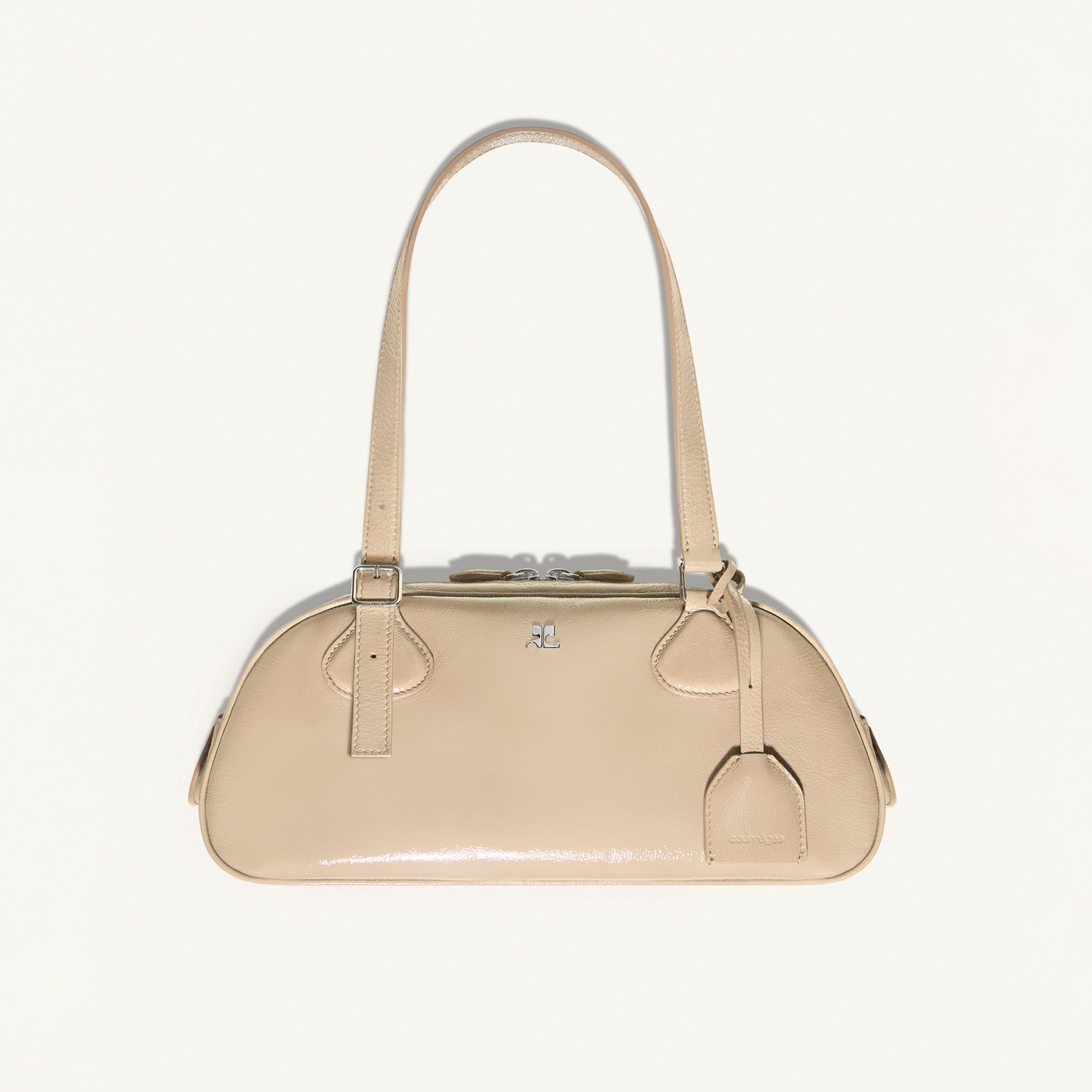 Elegant beige Courrèges handbag with silver accents, perfect for modern fashion statements.