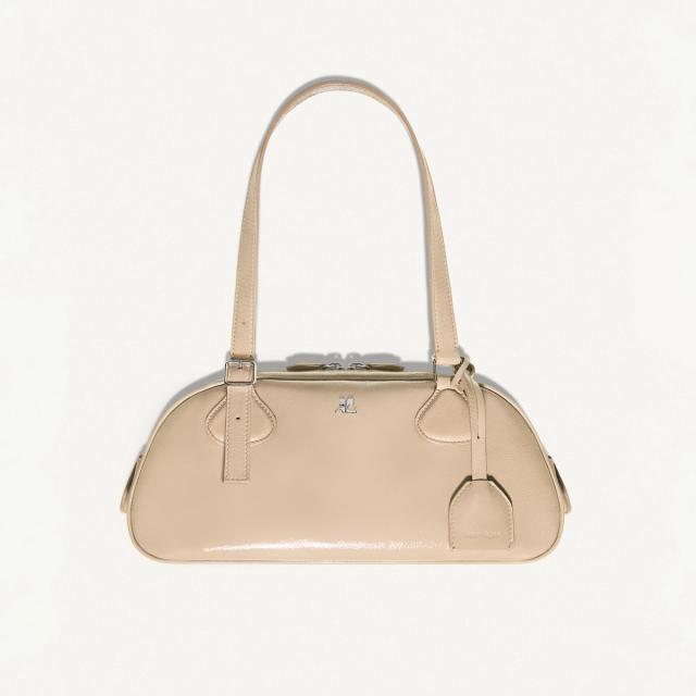 Elegant beige Courrèges handbag with silver accents, perfect for modern fashion statements.
