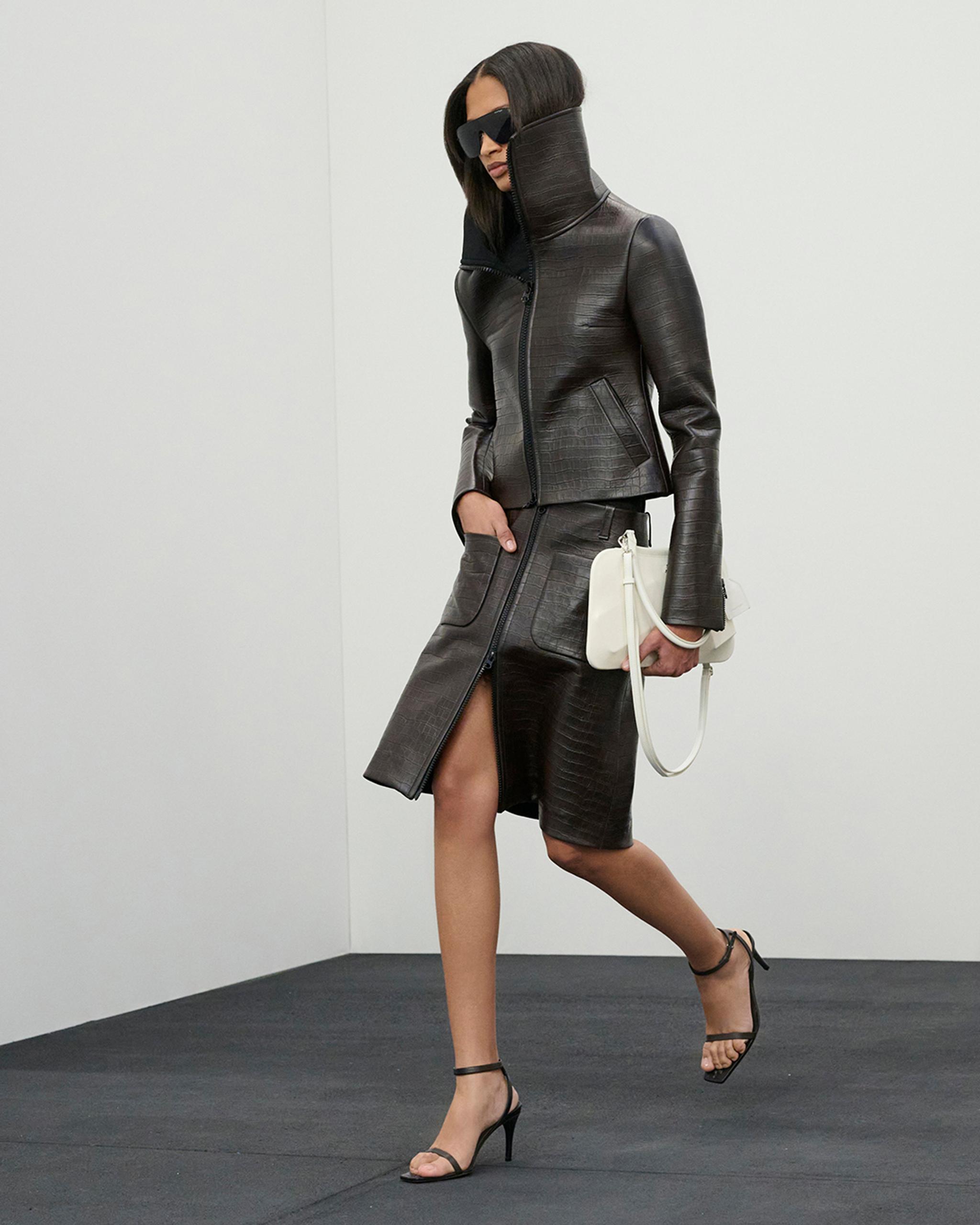 Elegant black leather outfit with a high collar, showcased on Courrèges fashion e-commerce site.