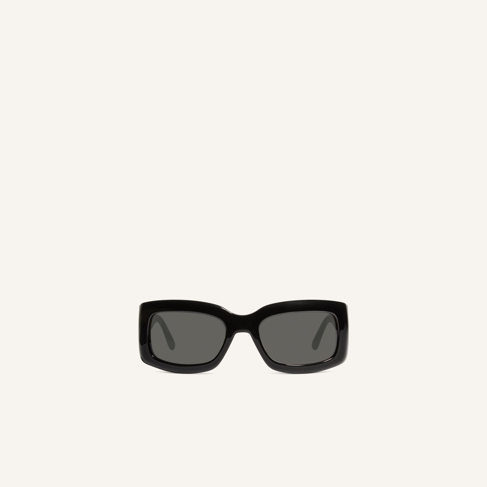 Elegant black sunglasses with a bold frame, high-quality material, designed for Courrèges fans.