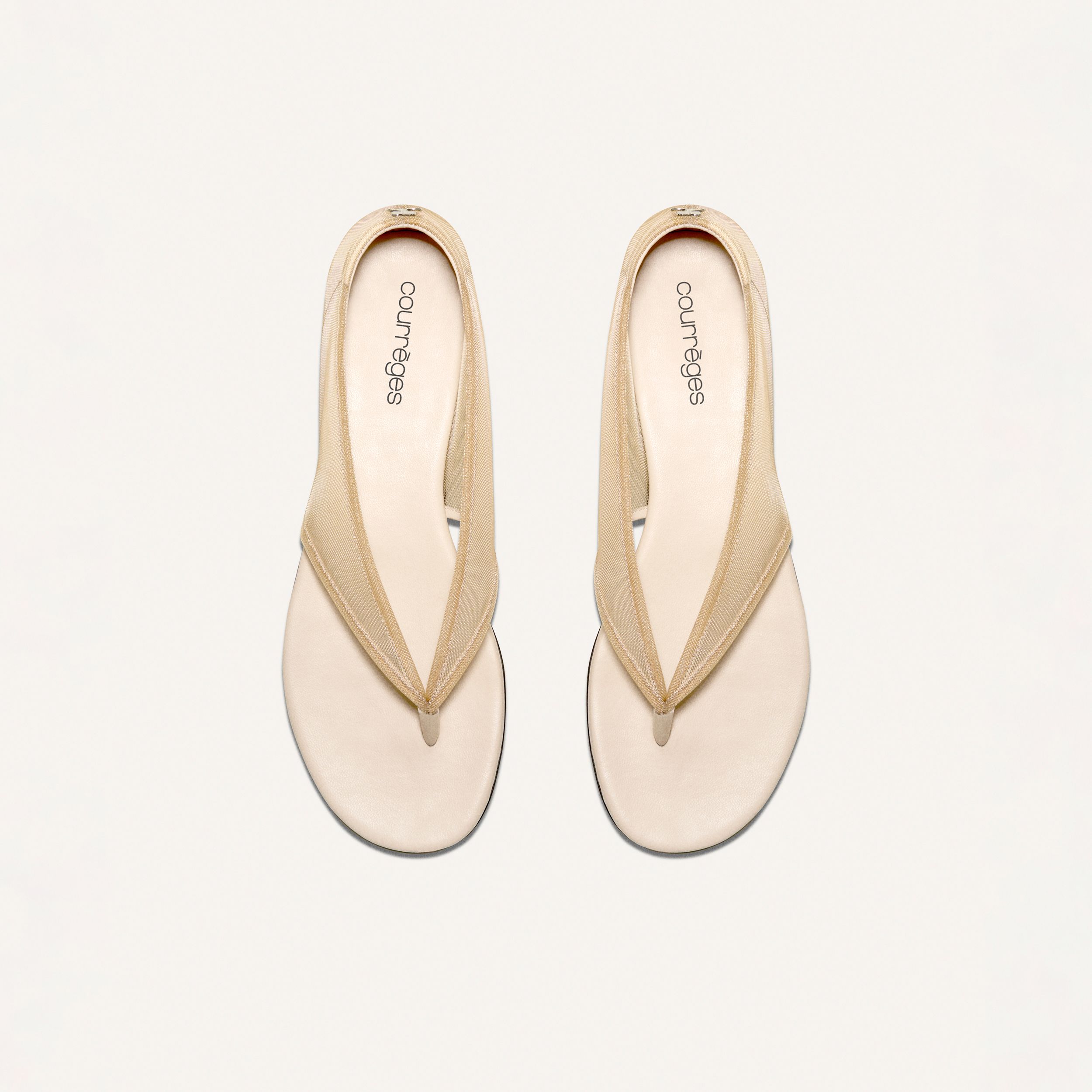 Elegant beige slippers from Courrèges, perfect for stylish fashion-forward footwear.
