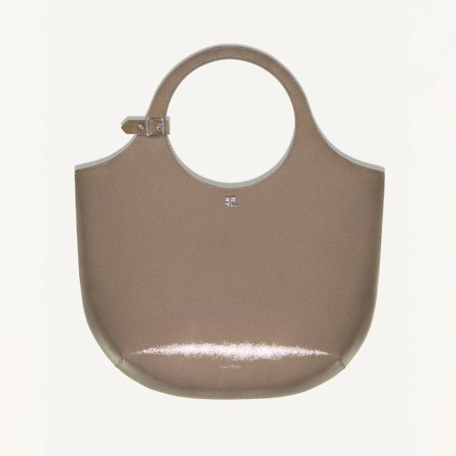 Elegant beige handbag by Courrèges with sleek round handle, perfect for chic fashion accessorizing.