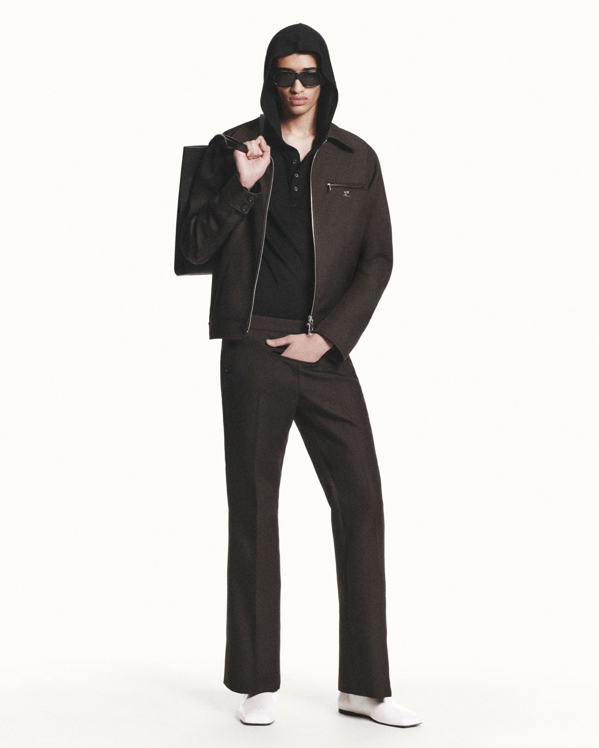 Elegant black and brown fashion look with Courrèges branding, perfect for an ecommerce site.