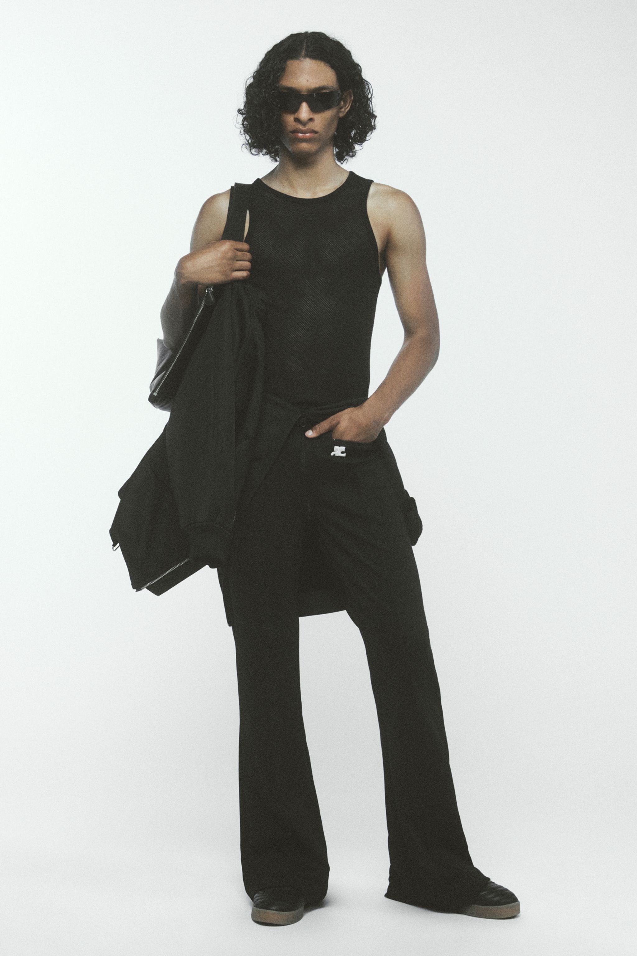 Elegant black sporty casual outfit featuring sunglasses, sleeveless top, and cargo pants for Courrèges.