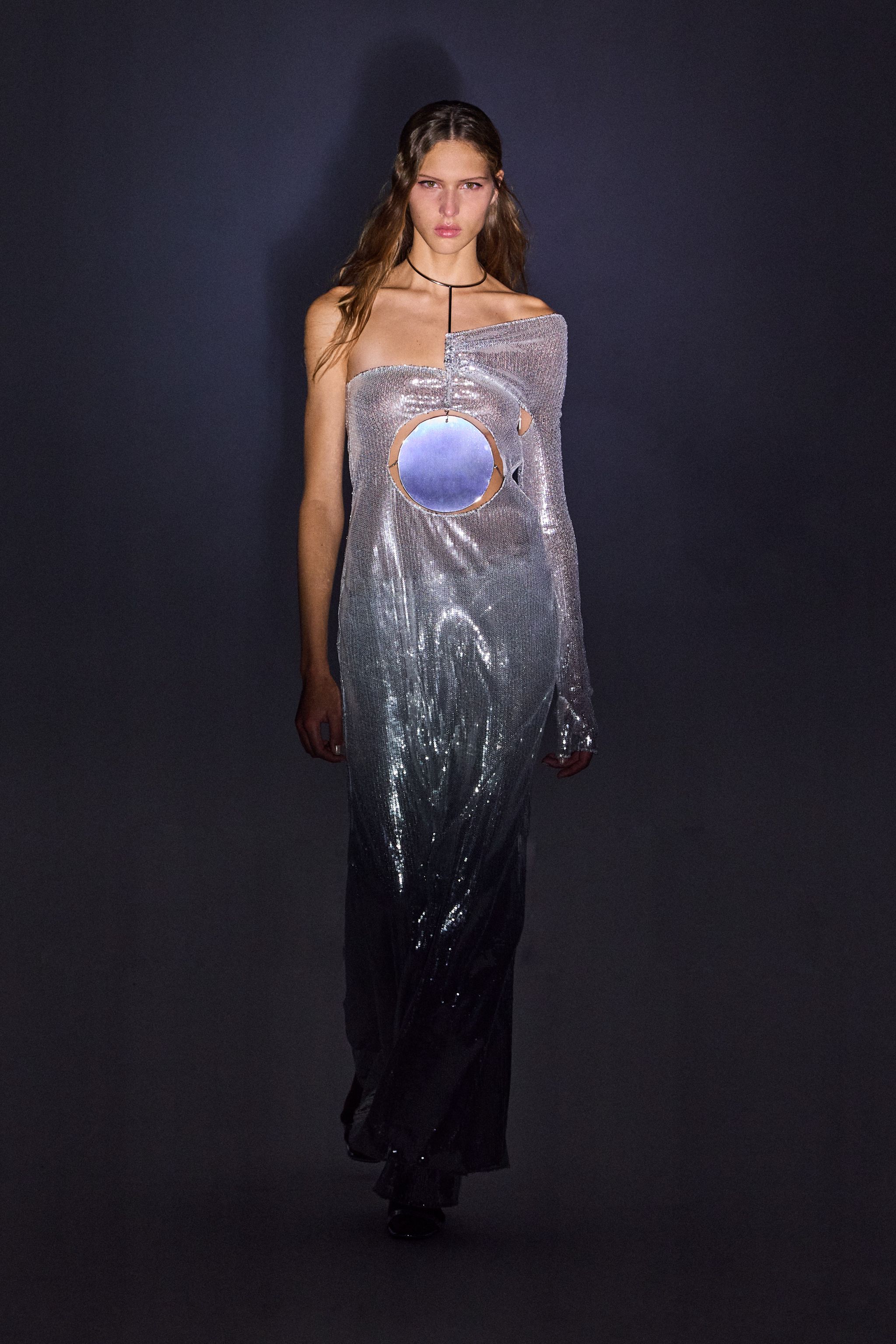 Elegant metallic dress with cutouts and oversized reflective circle, designed for Courrèges fashion.