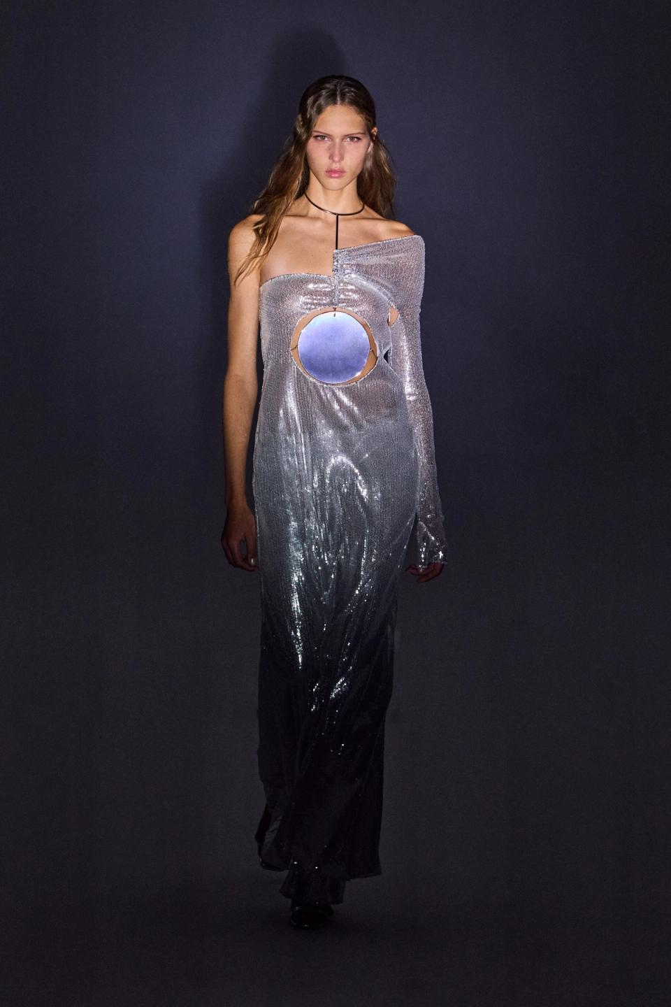 Elegant metallic dress with cutouts and oversized reflective circle, designed for Courrèges fashion.