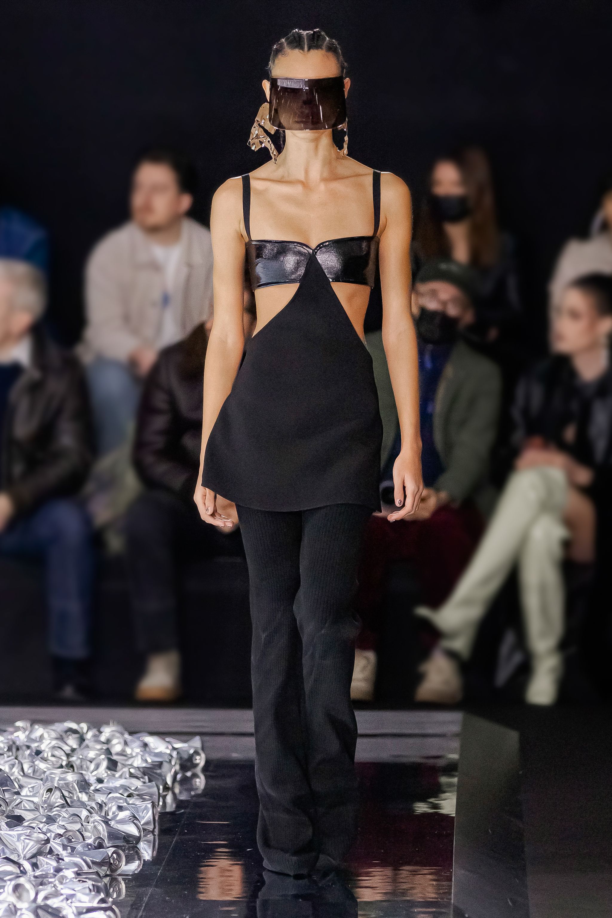Elegant black fashion dress with cut-outs and futuristic visor, Courrèges runway, urban style.