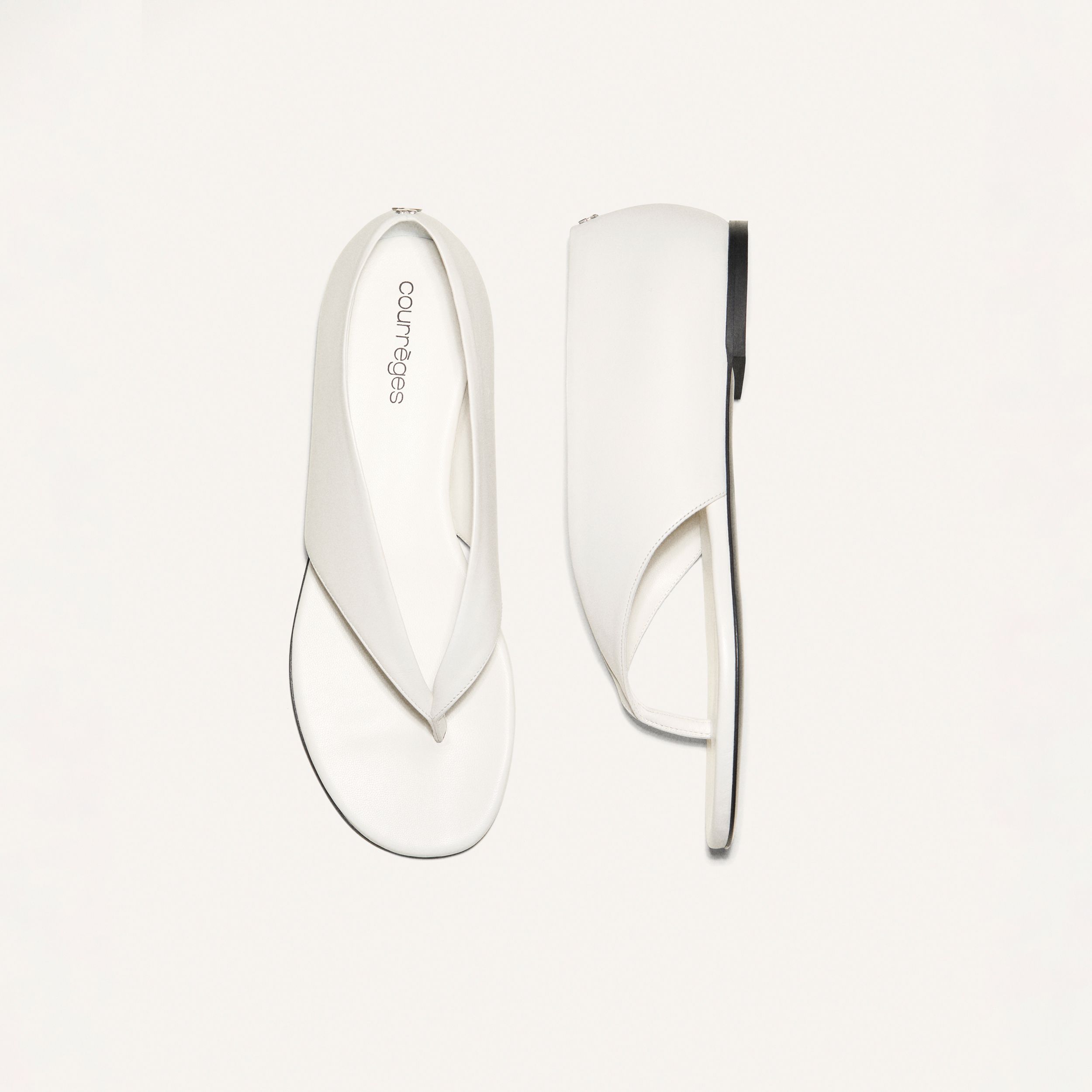 Elegant white Courrèges platform sandals showcasing contemporary minimalist design, perfect for chic fashion.