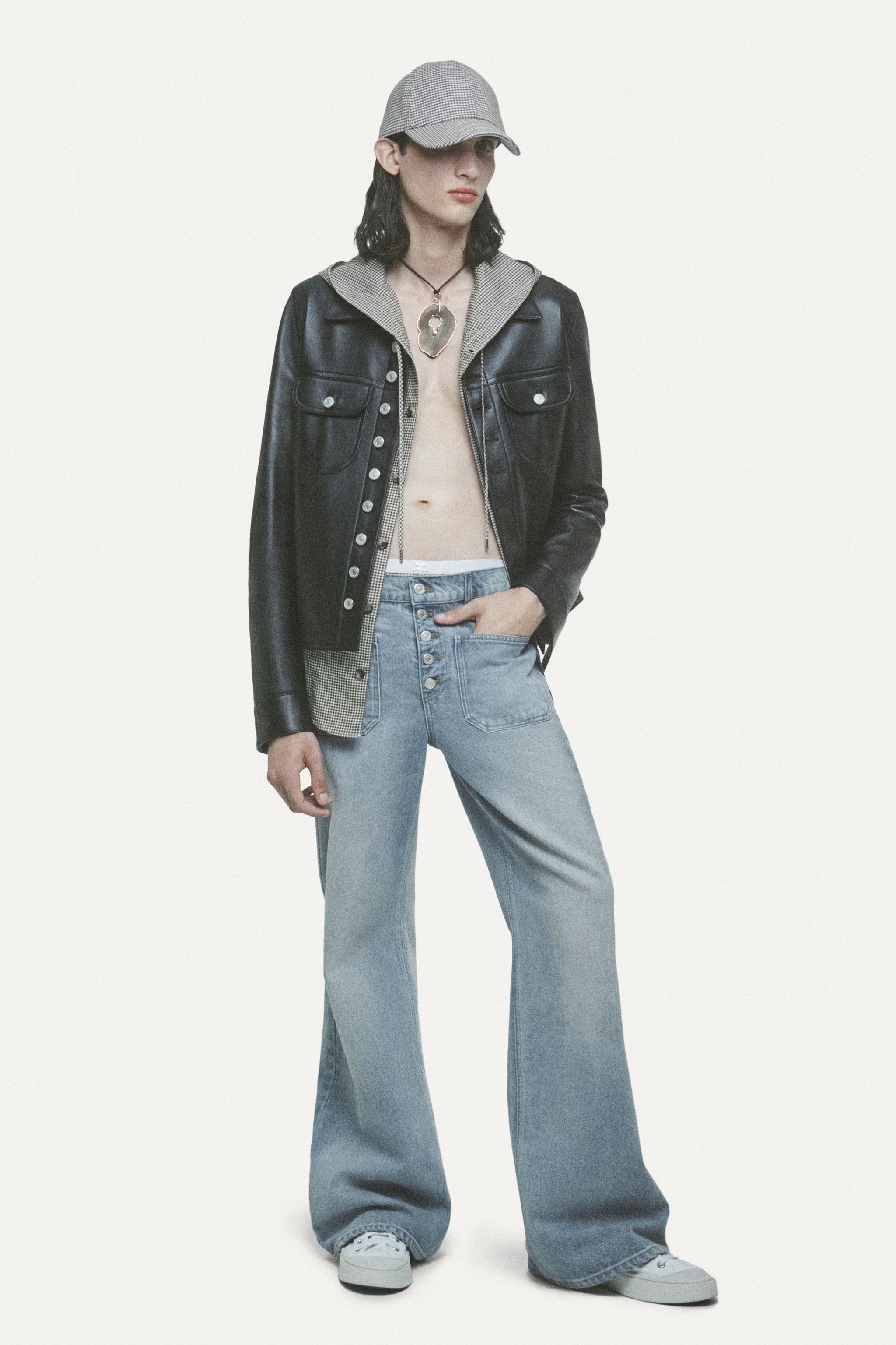 Fashion model in casual denim and leather jacket, wearing Courrèges stylish accessories.