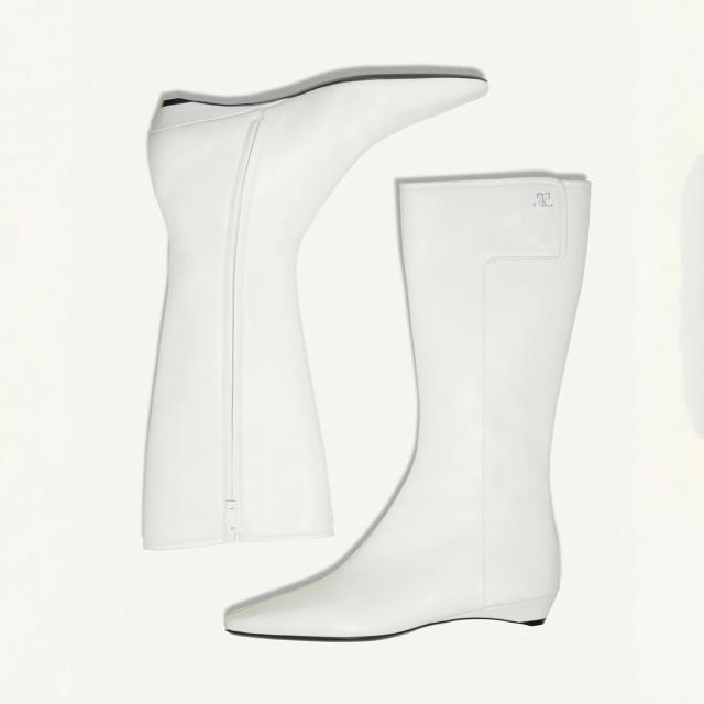 Elegant white knee-high boots featuring a sleek design, perfect for Courrèges fashion collection.