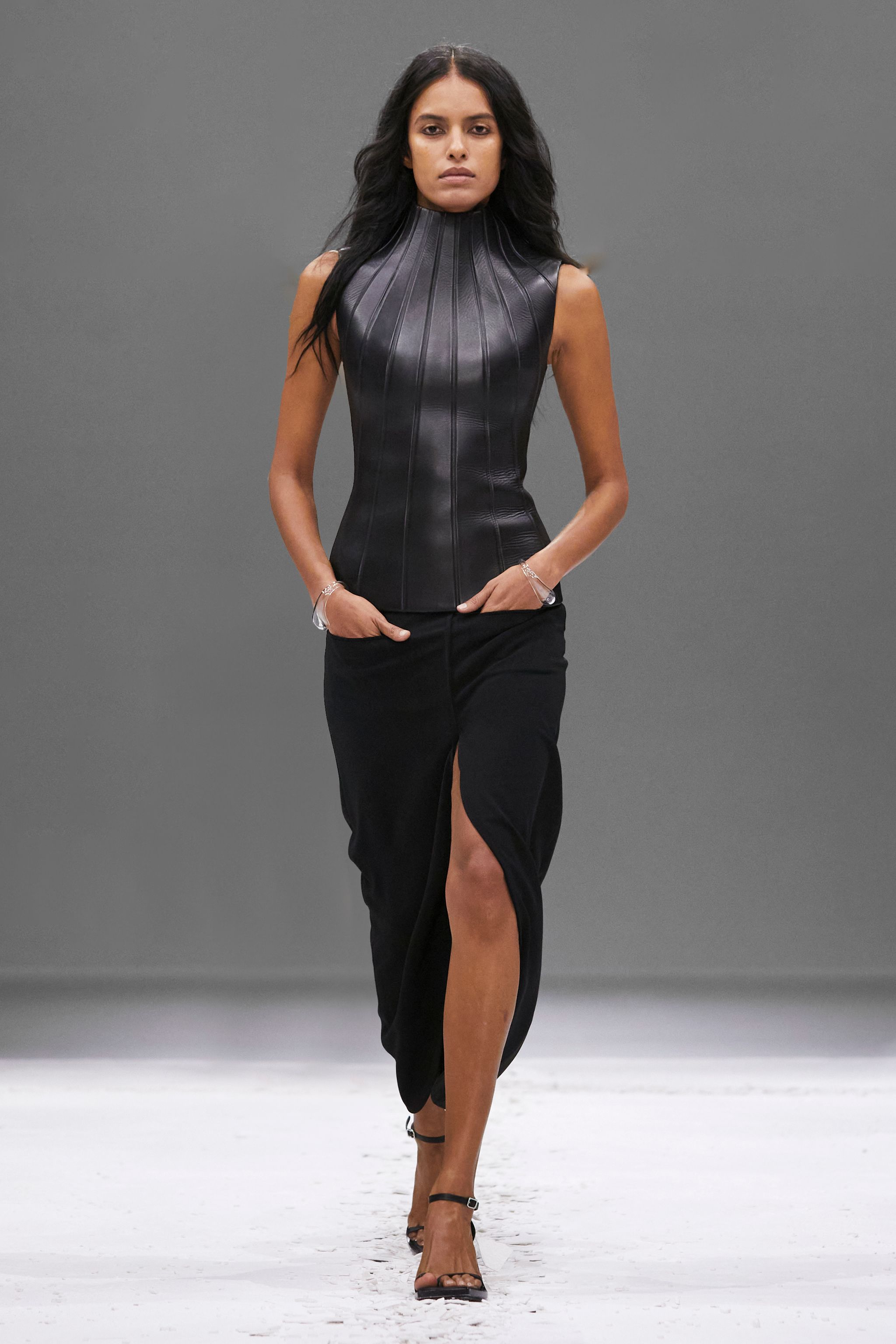 Elegant black leather top and skirt, chic Courrèges fashion for sophisticated style.