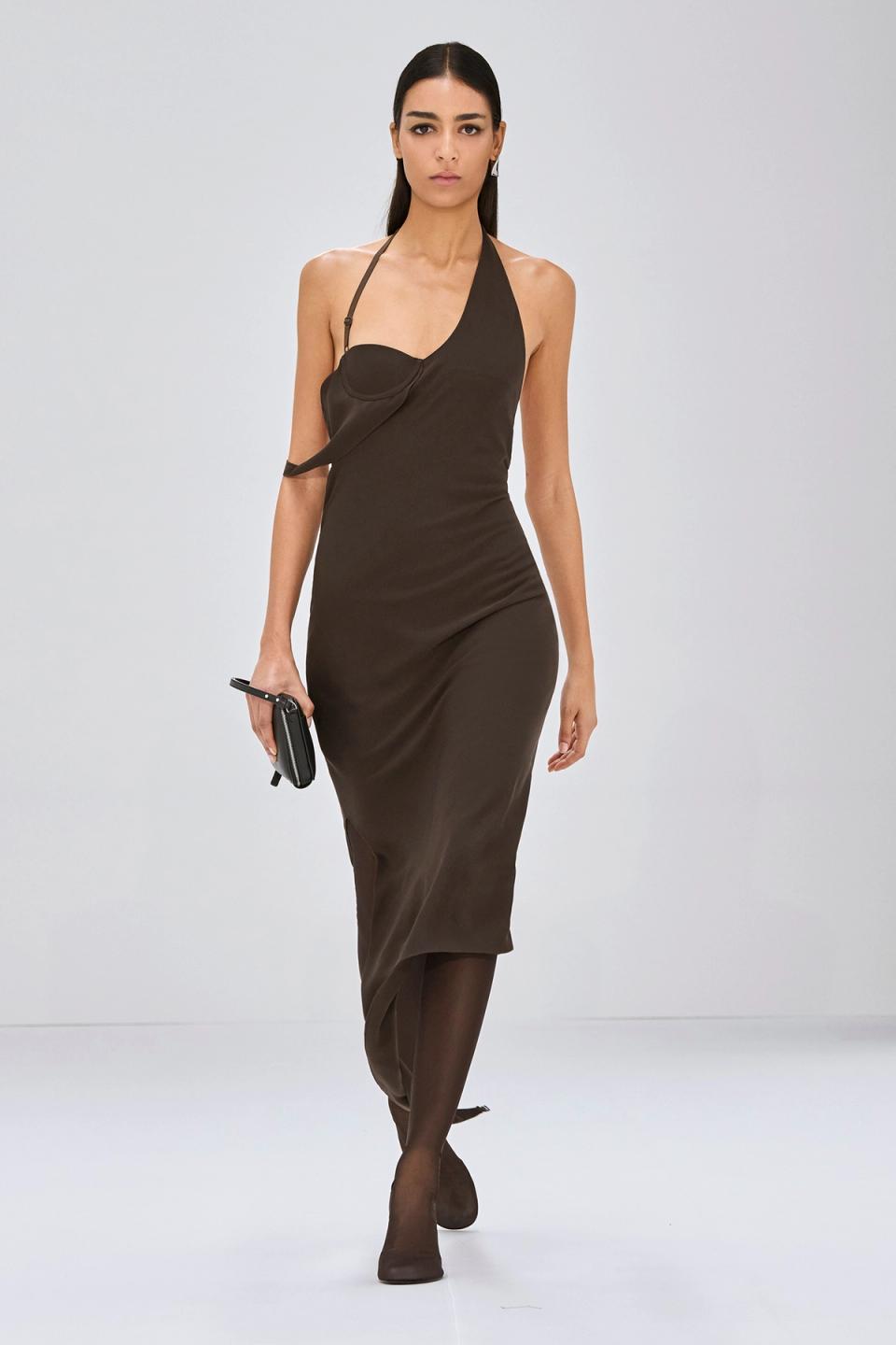 Elegant black fashion ensemble with a strapless top, long skirt, and futuristic sunglasses by Courrèges.