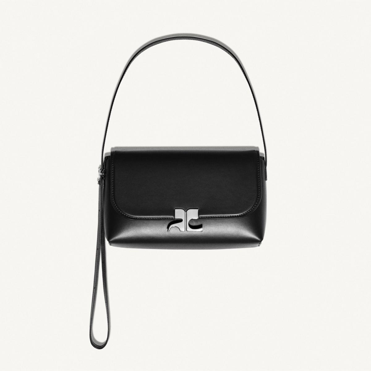 Elegant black handbag by Courrèges, featuring a sleek design with silver hardware for fashion-forward style.