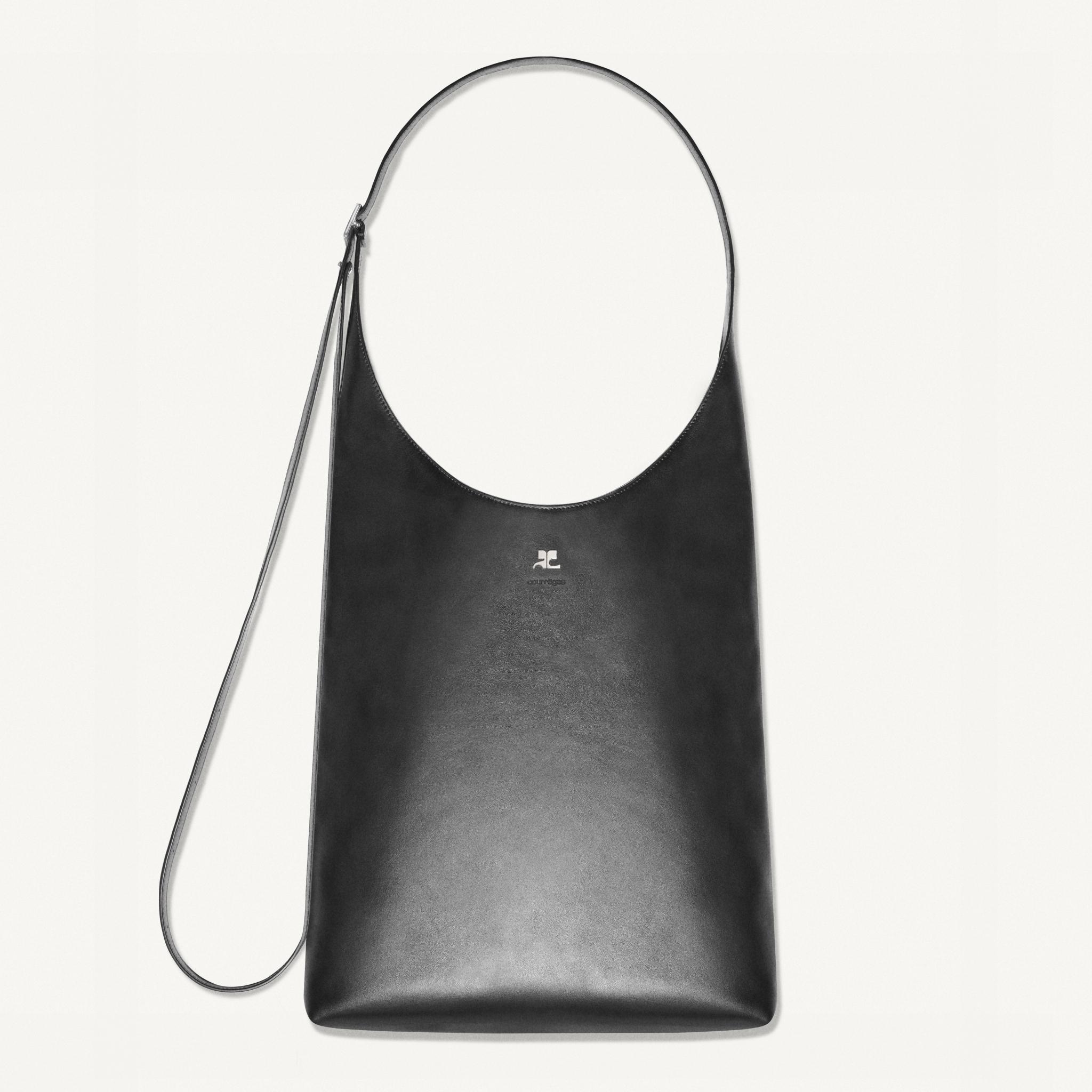 Elegant black leather tote bag with Courrèges logo, perfect for modern fashion accessories.