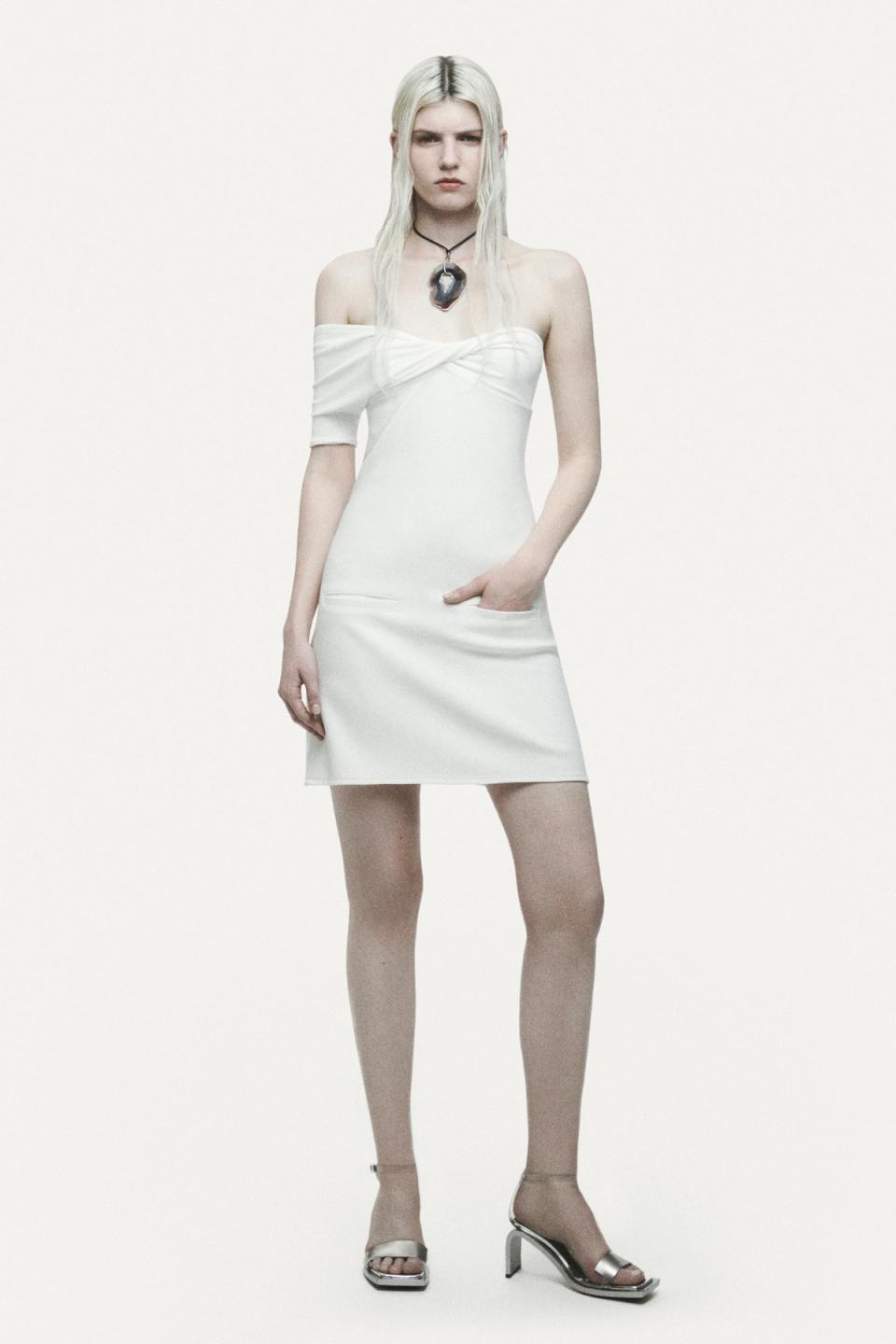Elegant black leather vest and wide-leg black pants showcased by Courrèges on an ecommerce site.