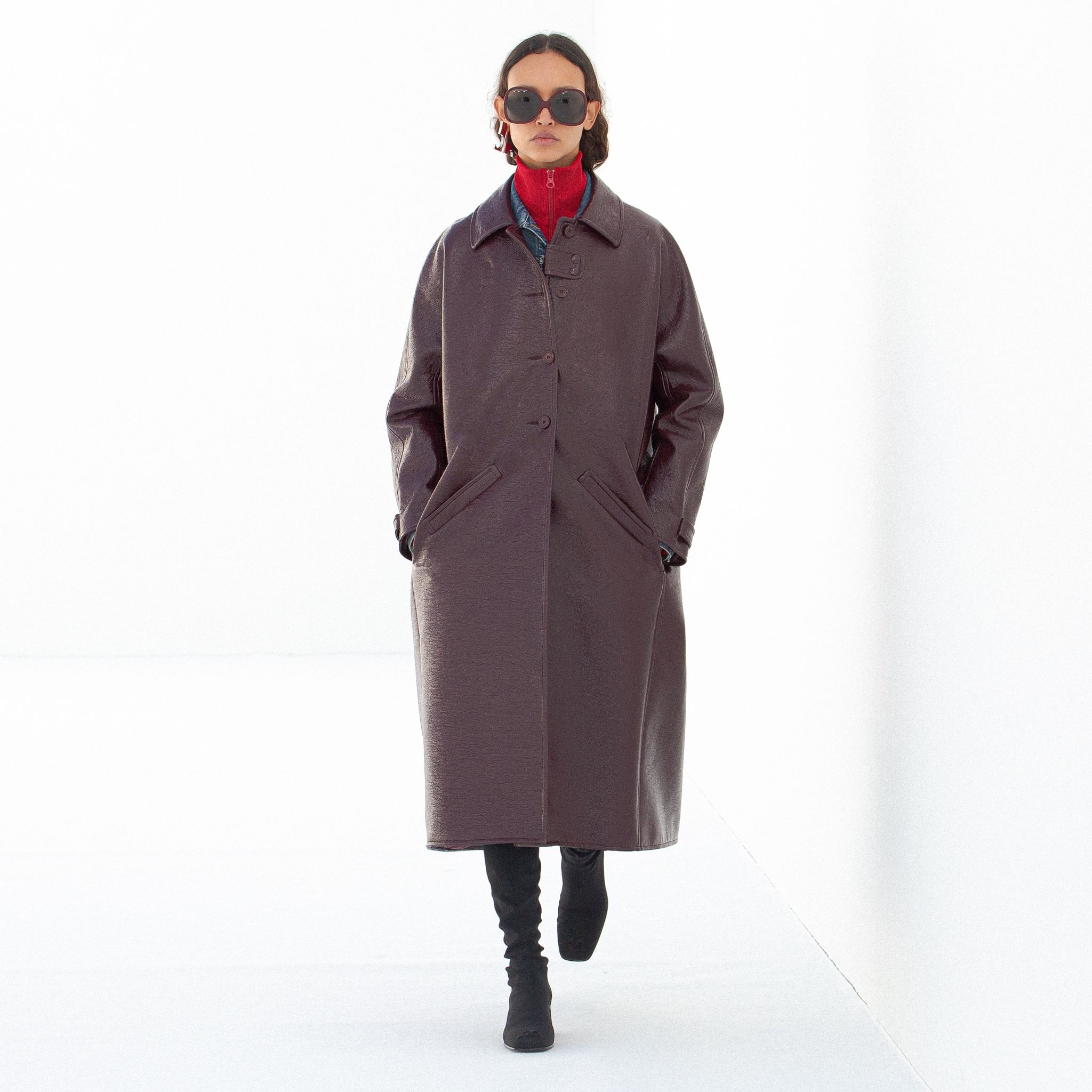 Elegant leather coat with a modern silhouette, styled for Courrèges fashion on an ecommerce site.