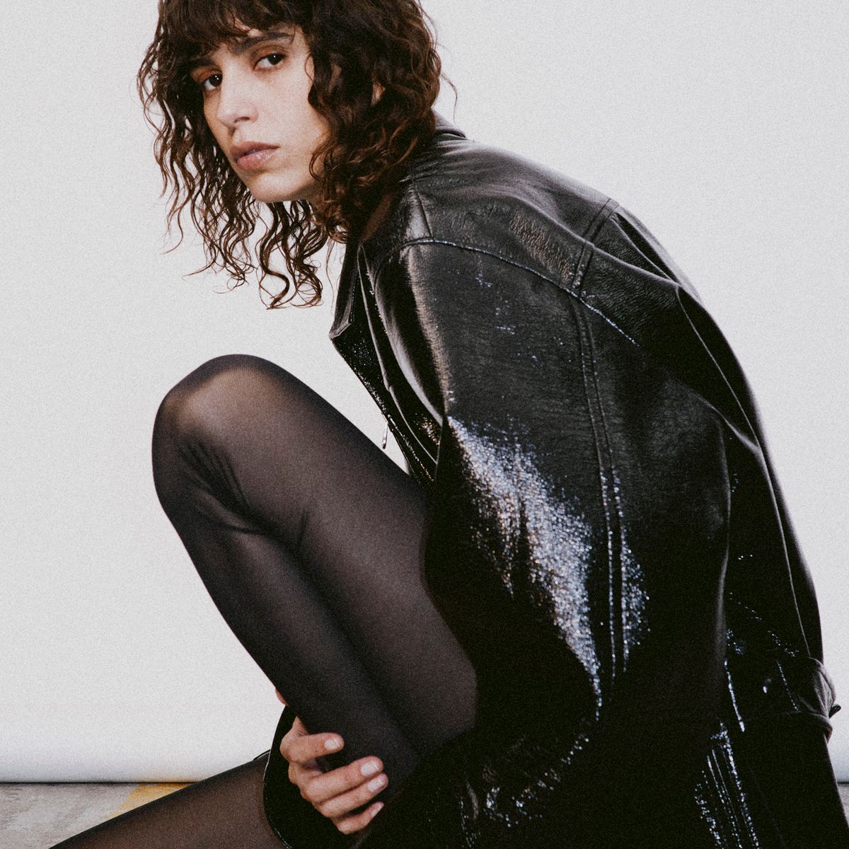 Elegant black leather jacket and tights for a chic Courrèges fashion look.